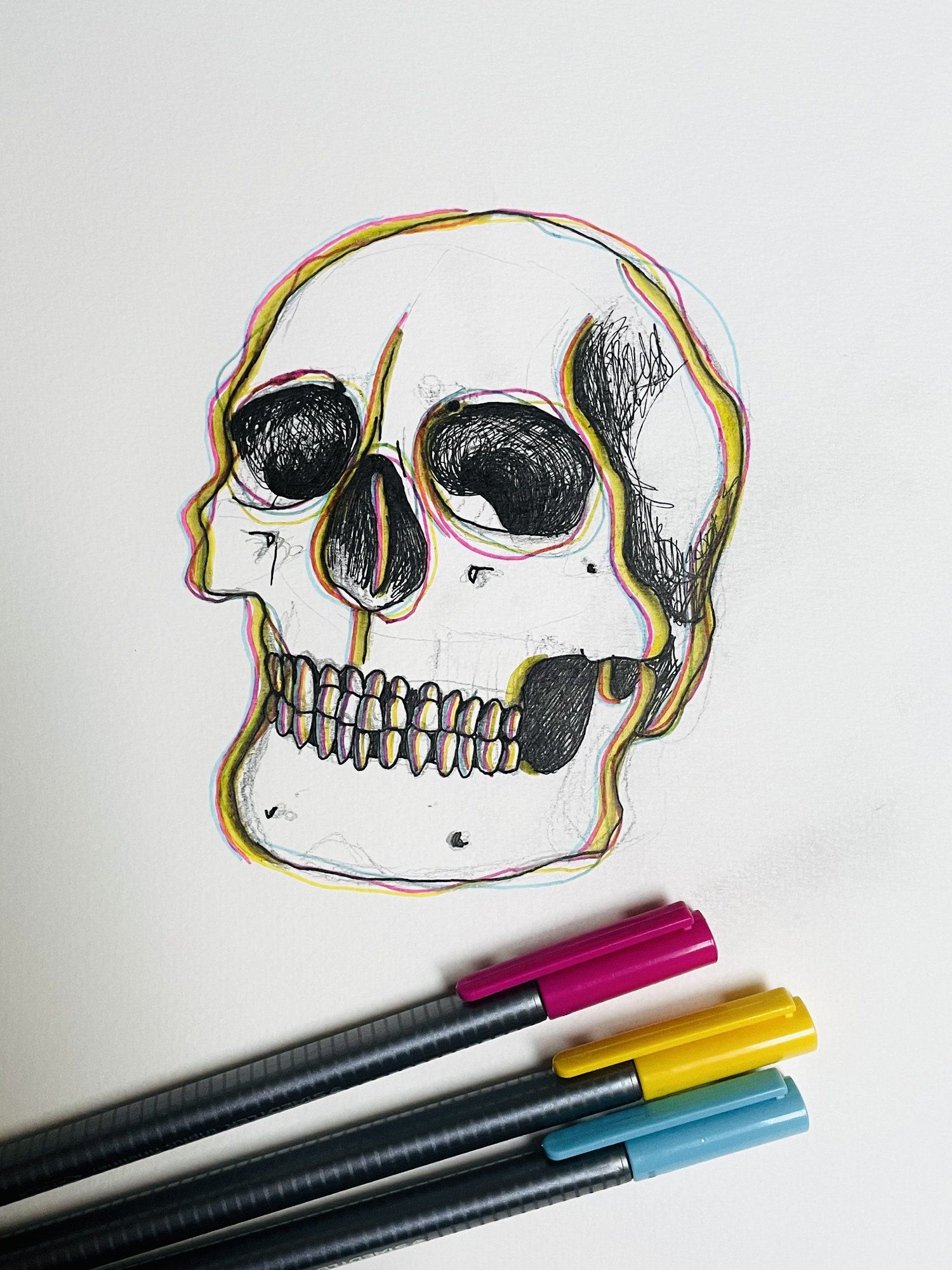 A sketch of a skull made with a pencil and coloured pens