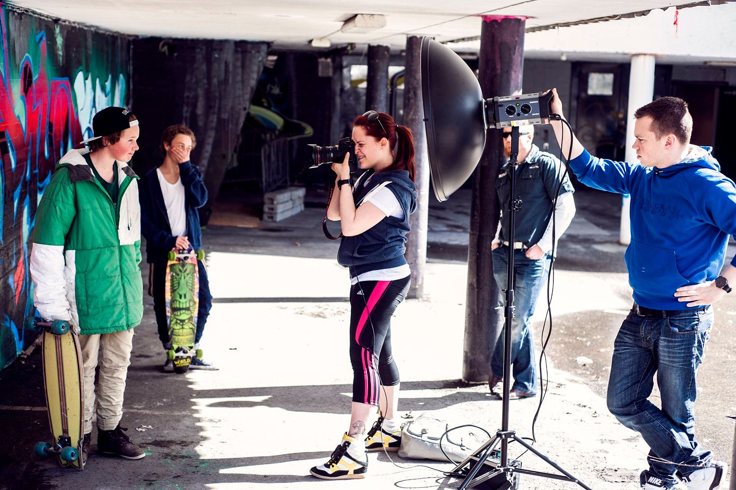 Tanja Renate Aakerøy on set taking pictures of two skaters with her assistants