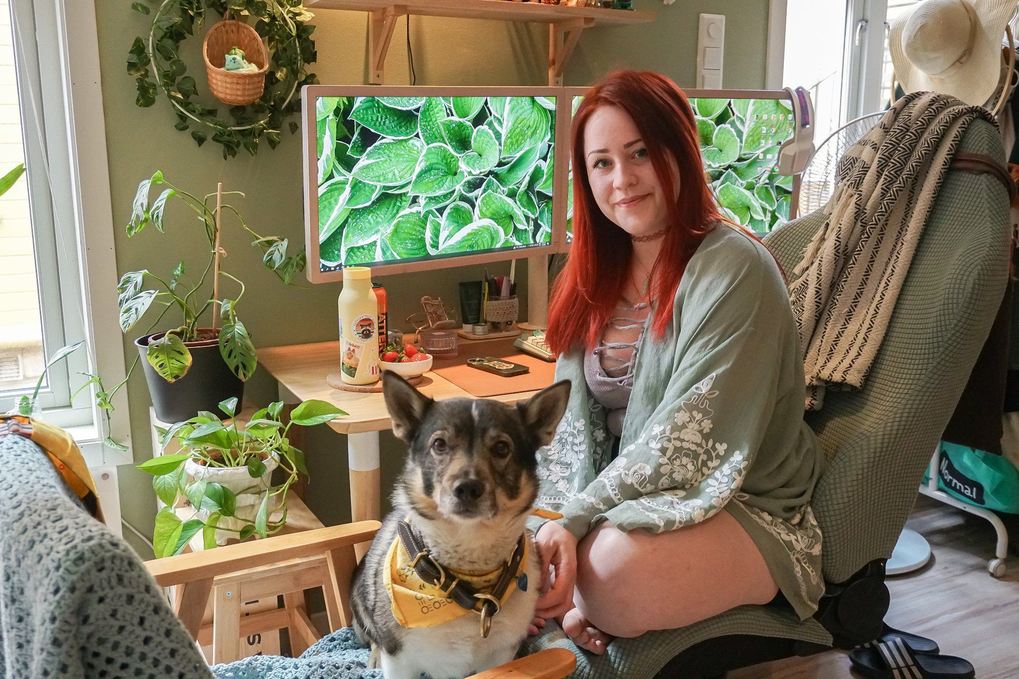 Tanja Renate Aakerøy in her green home office with her dog Atlas