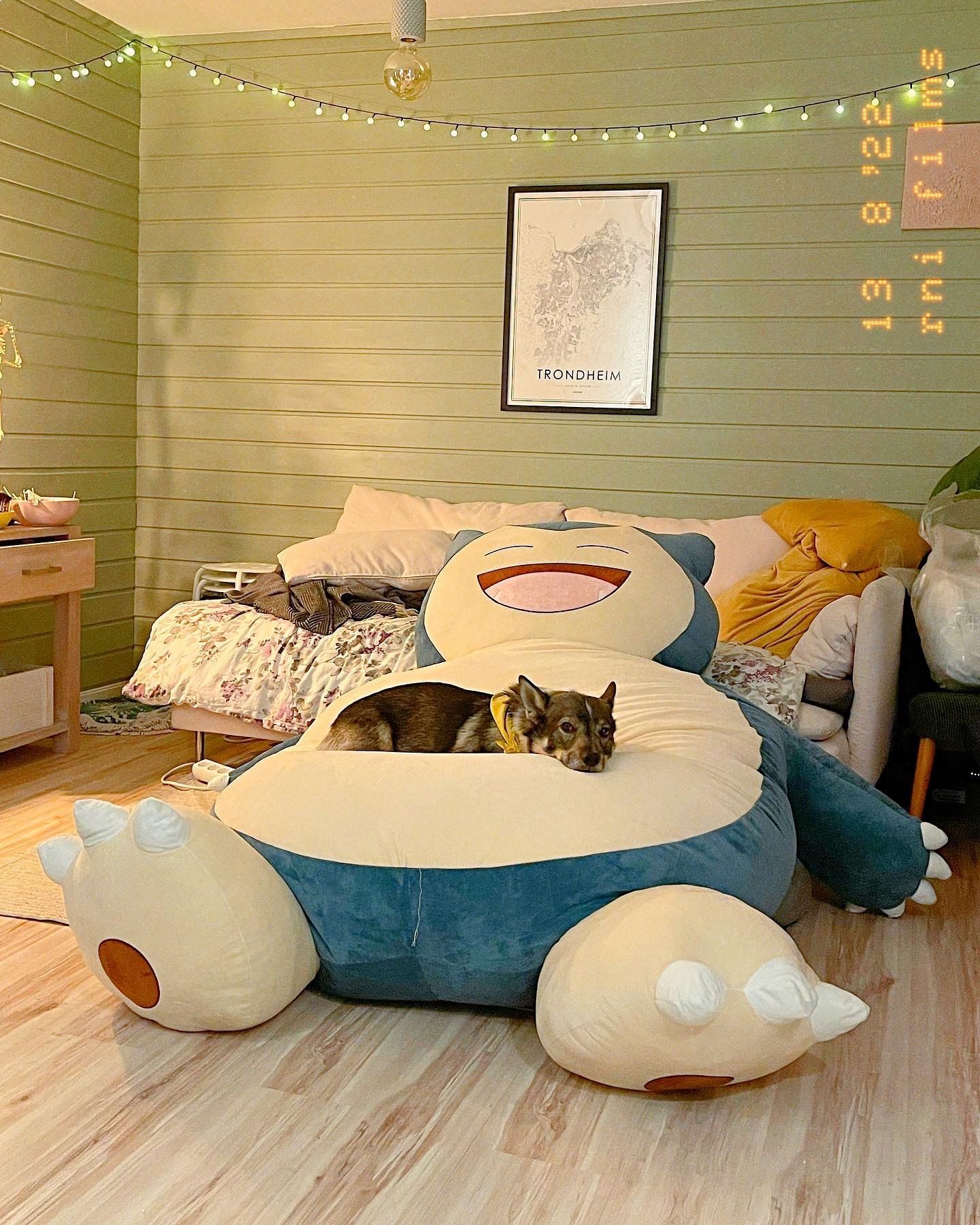 A dog relaxing on a giant plush Snorlax bean bag