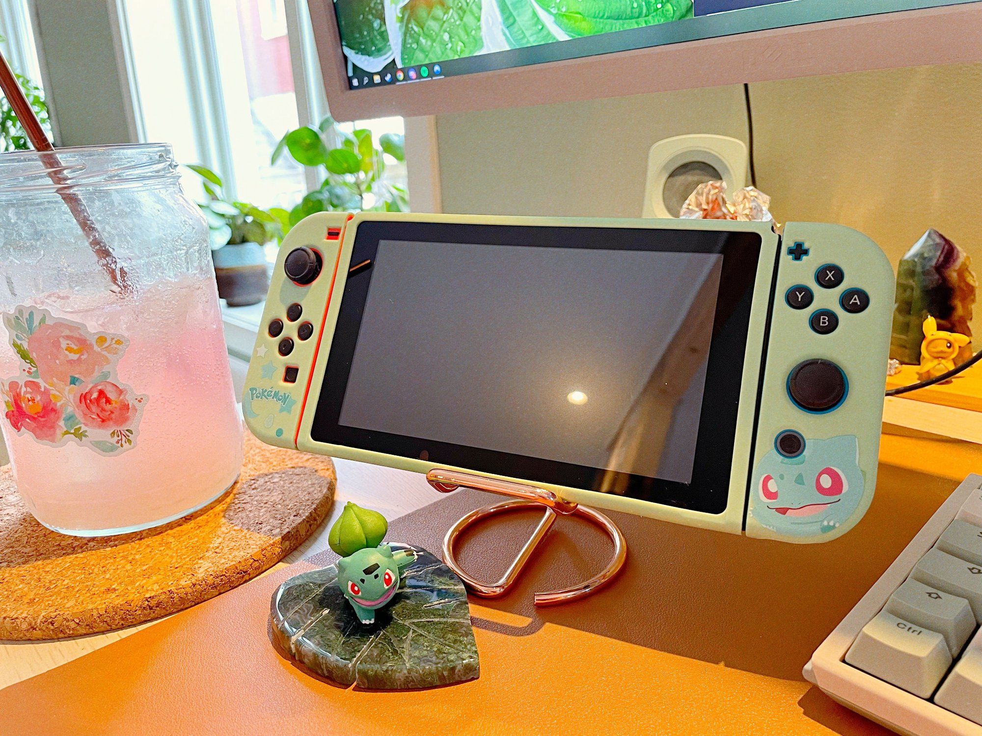 Rose water in a jar with a rose sticker and a Nintendo Switch in a Pokémon-themed skin