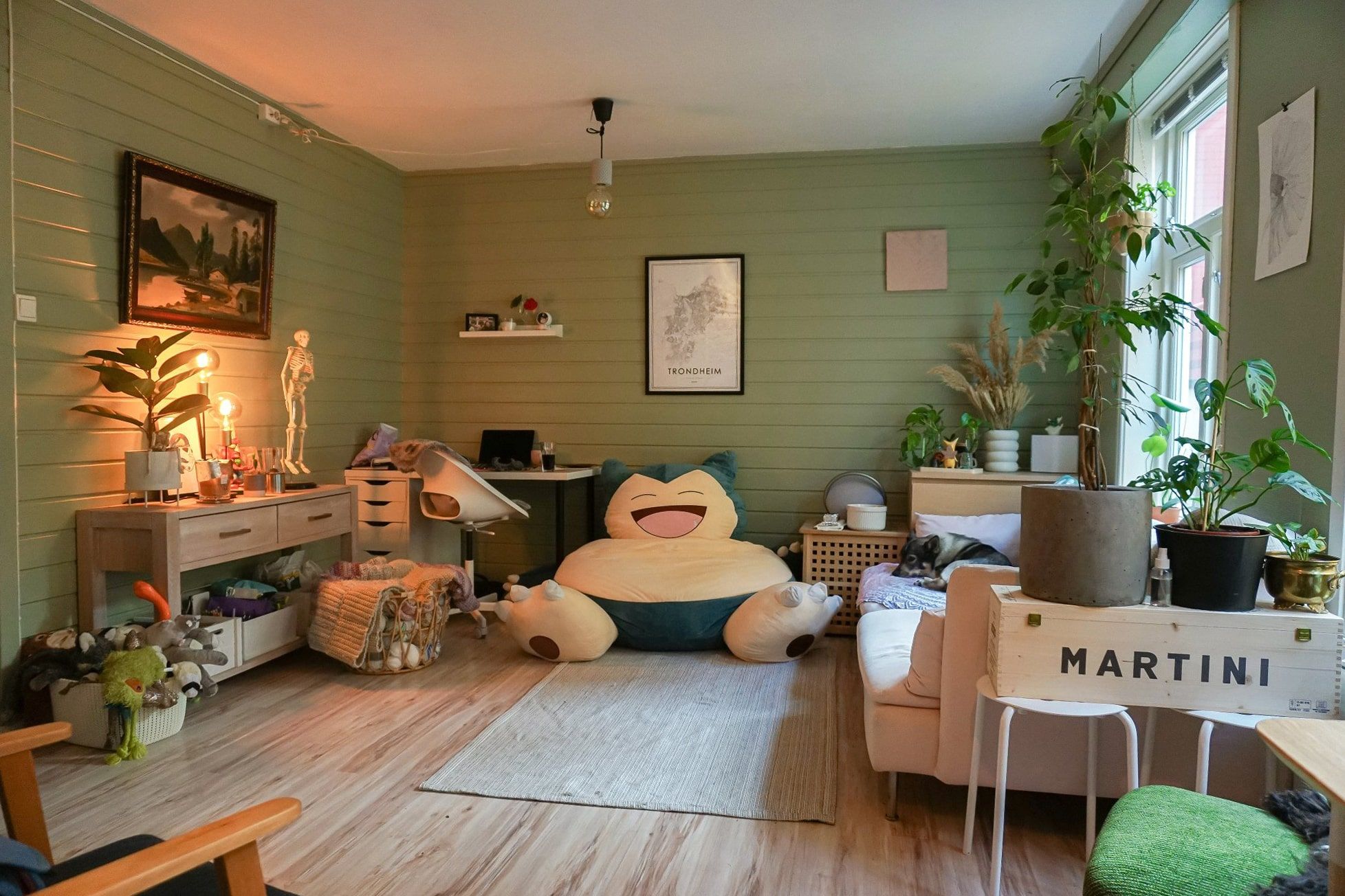 A calm and inviting living room with a giant Snorlax bean bag and lots of greenery