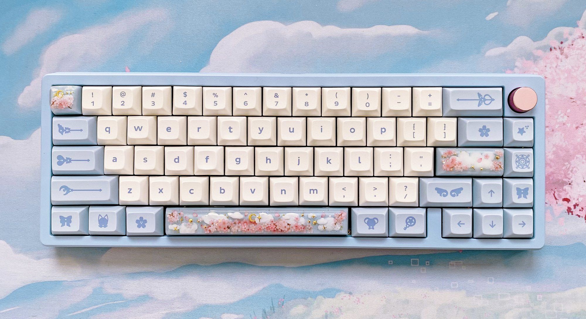 A customised white, blue, and pink Zoom 65 mechanical keyboard