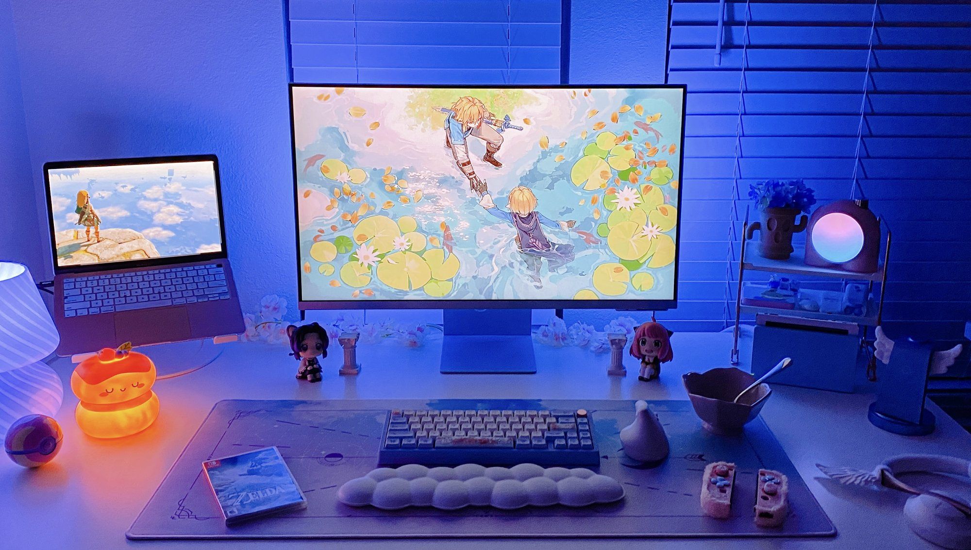 A desk setup with a smart Samsung M8 monitor, an Apple MacBook Air laptop, and a Zoom 65 EE mechanical keyboard