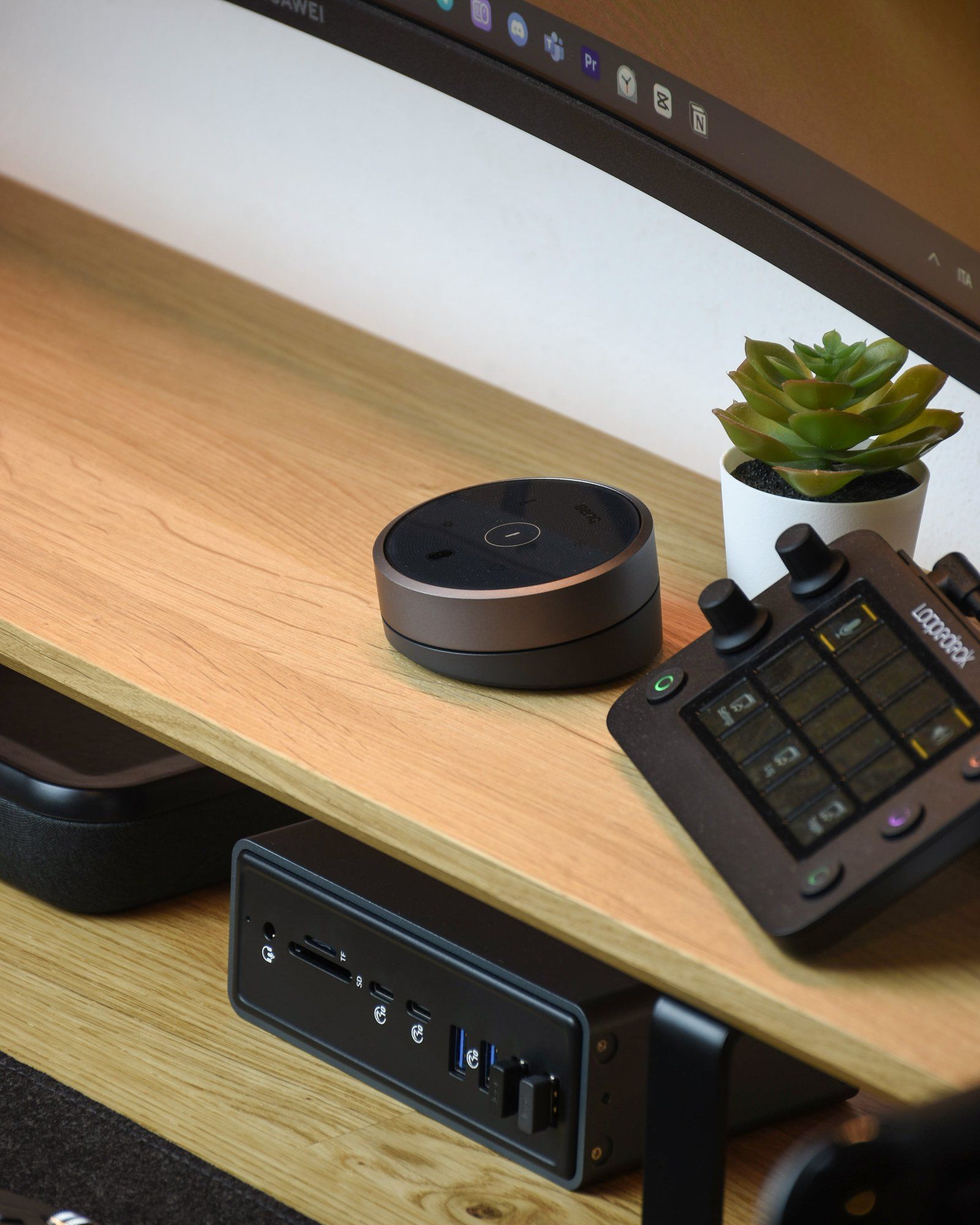 A BenQ Halo controller sitting on a desk shelf