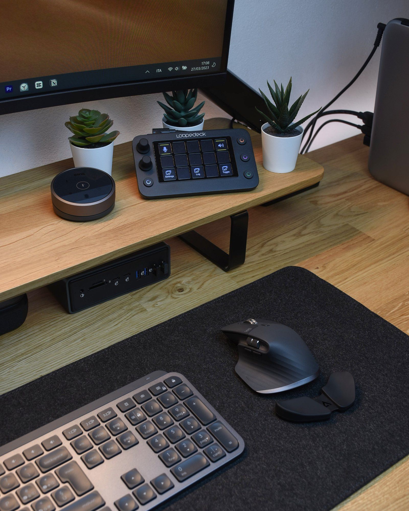 A close-up shot of an ergonomic desk setup with peripherals