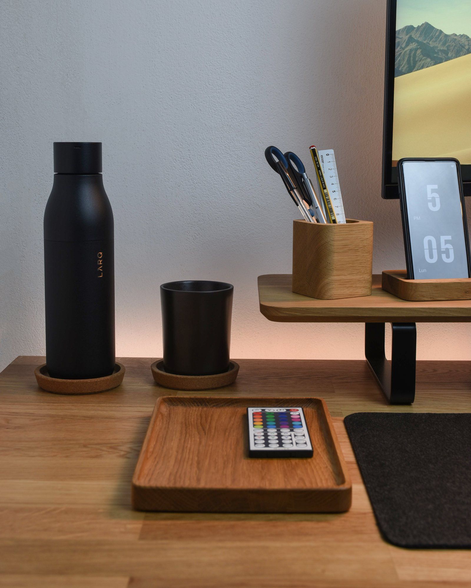 A well-organised desk setup featuring a wooden tray and other accessories