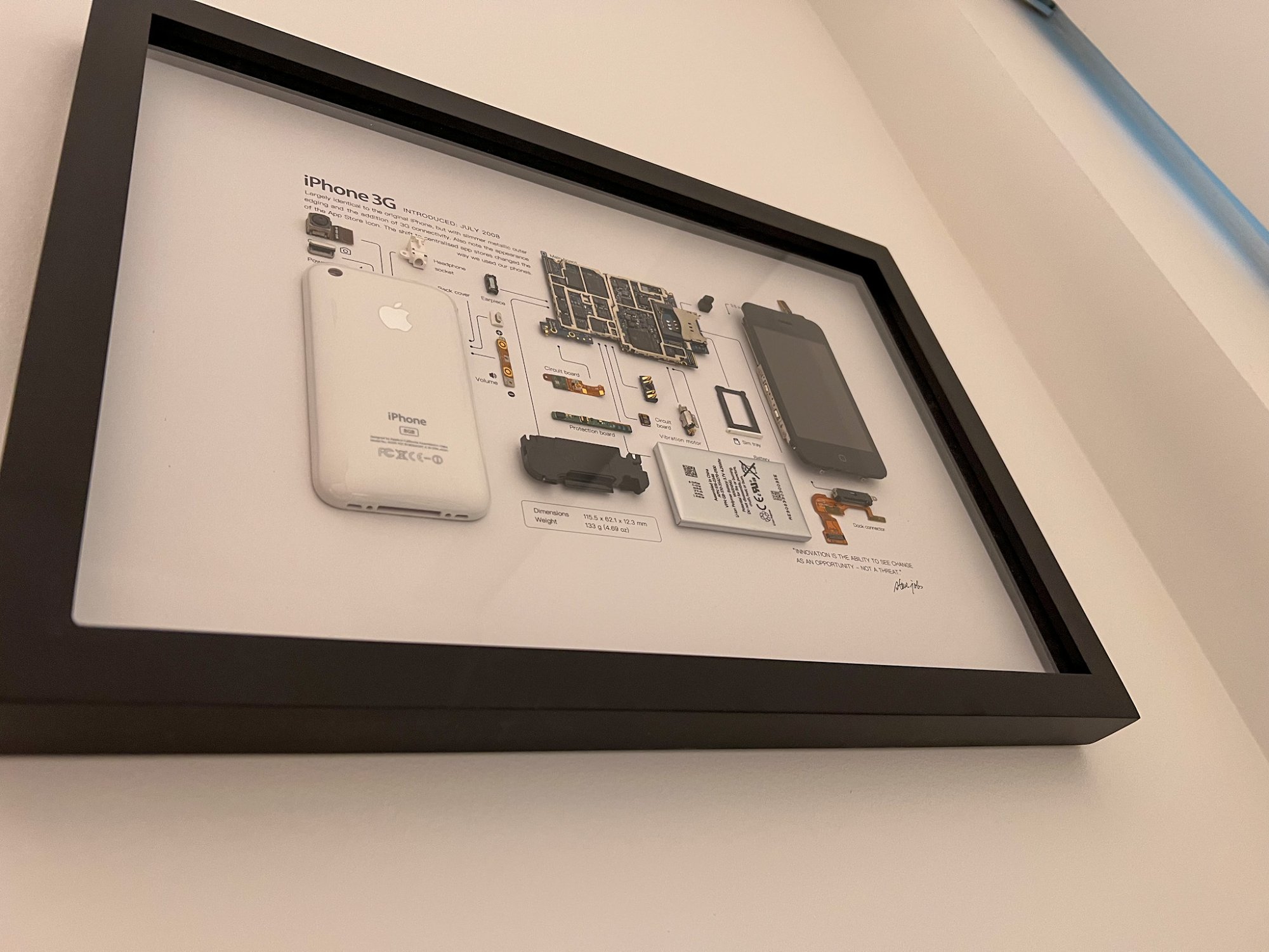 A close-up shot of a framed disassembled iPhone 3G from GRID