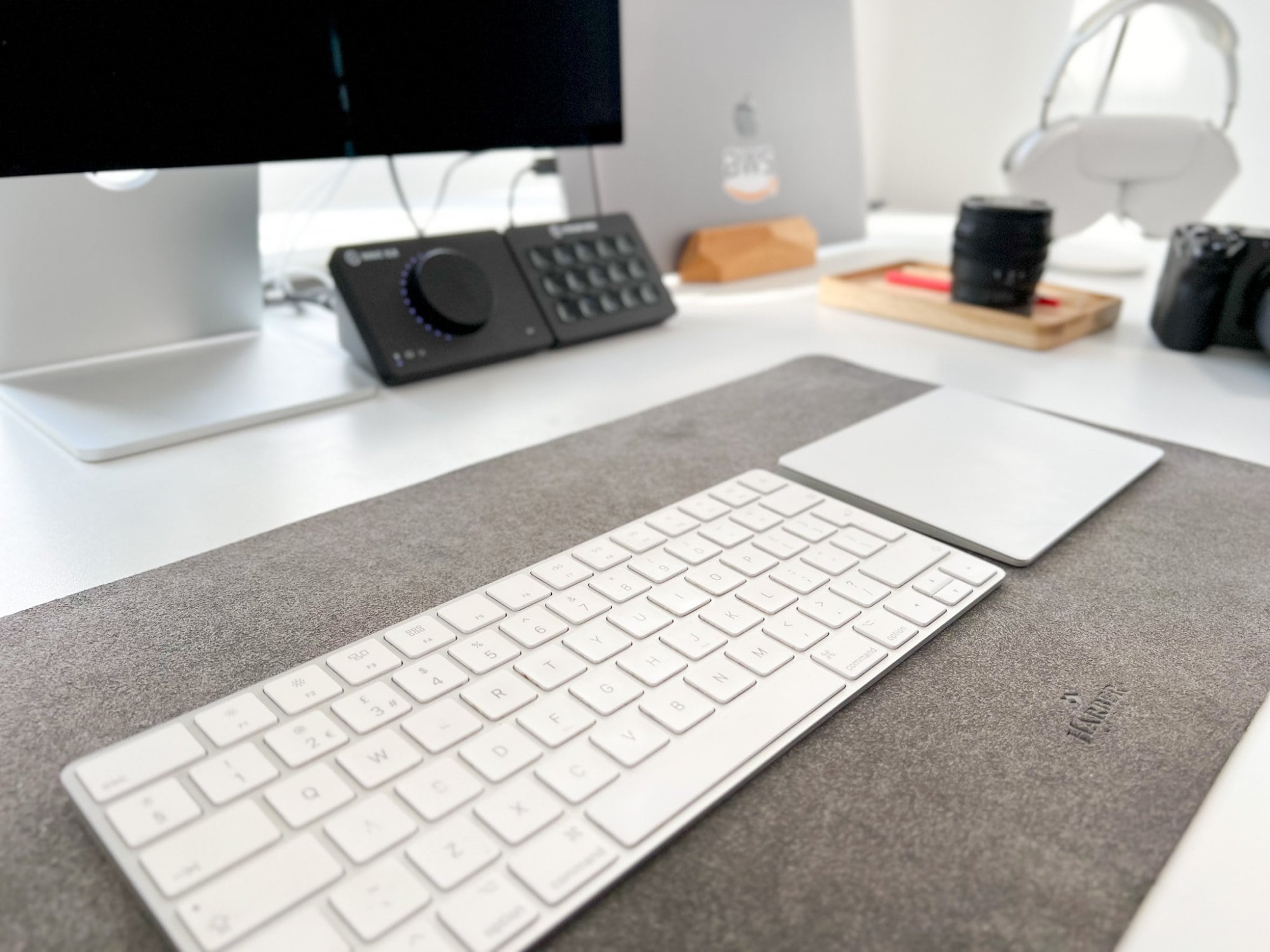 An Apple Magic keyboard and trackpad sitting on a Harber London microfibre desk mat