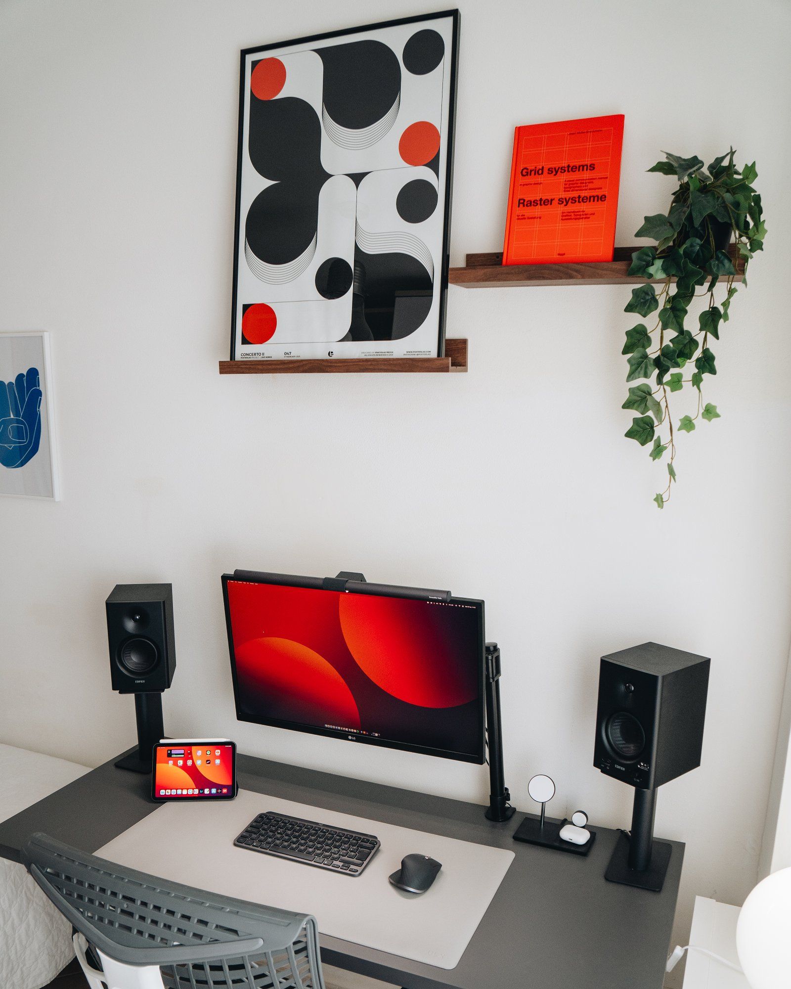 A minimal desk setup with a Concerto II poster by Posterlad on a floating shelf