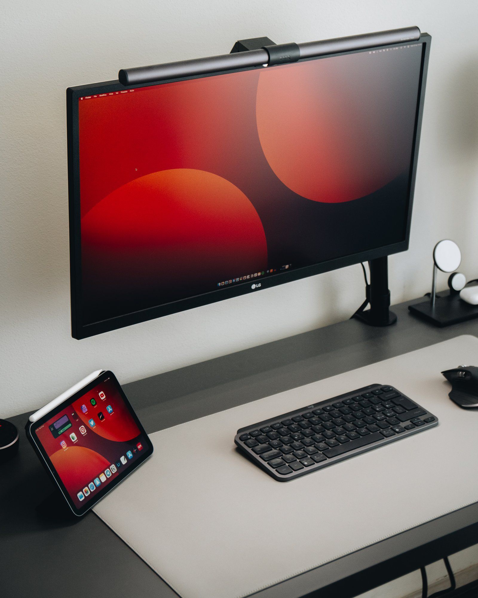 A minimalistic desk setup with an LG monitor, Apple iPad Pro, and Logitech MX Keys Mini keyboard
