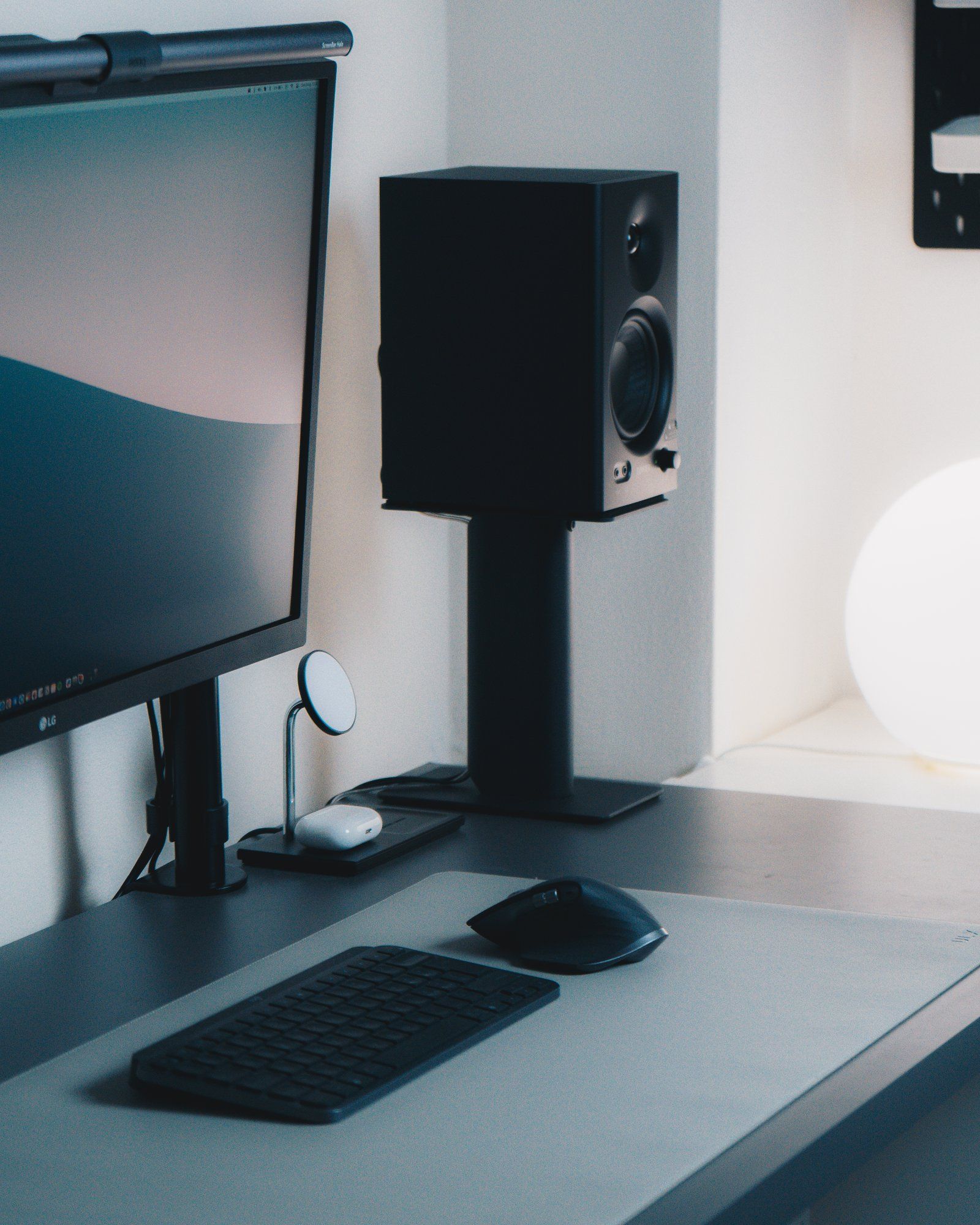 An Edifier MR4 speaker on a Kanto stand in the minimal desk setup