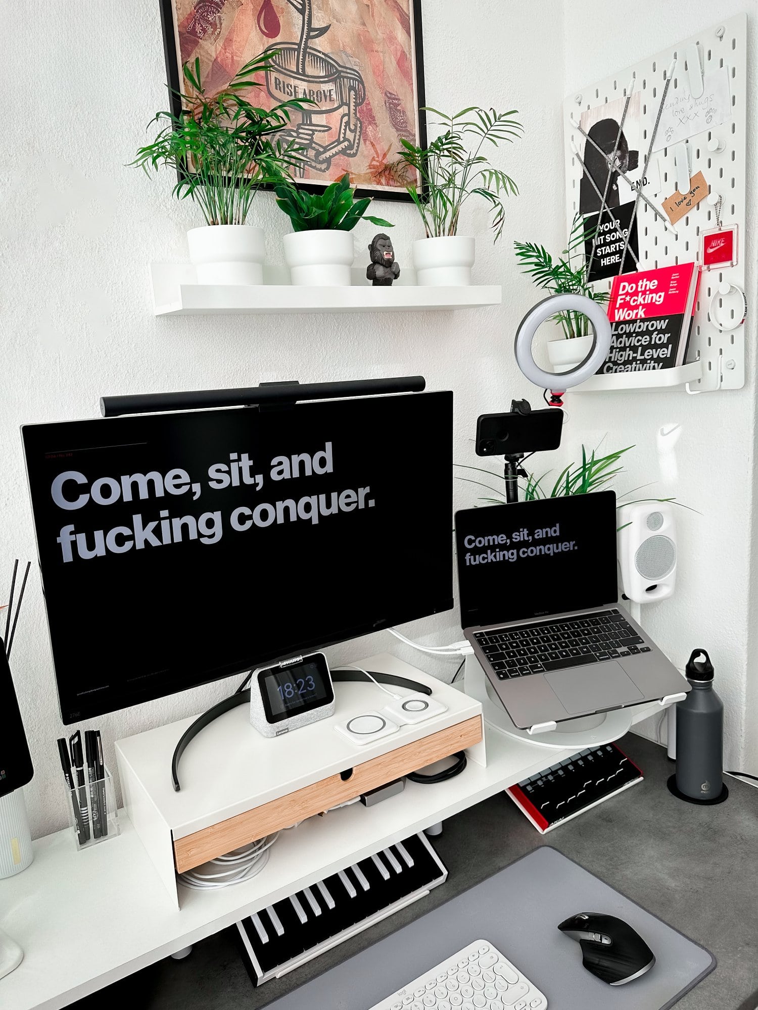 A productive desk setup for working from home featuring a Philips 4K monitor and a MacBook Pro