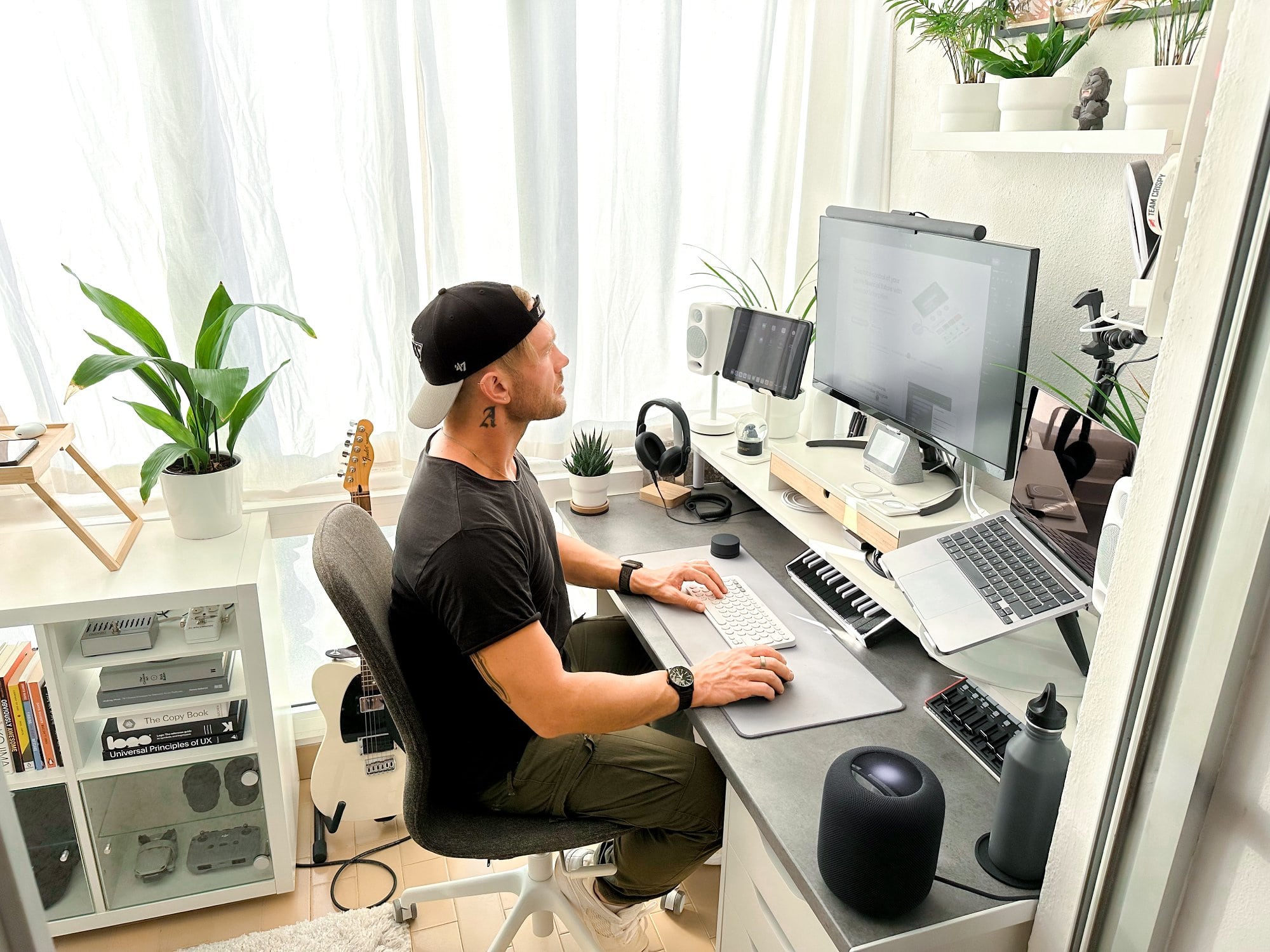 A copywriter and music producer at his small IKEA desk setup