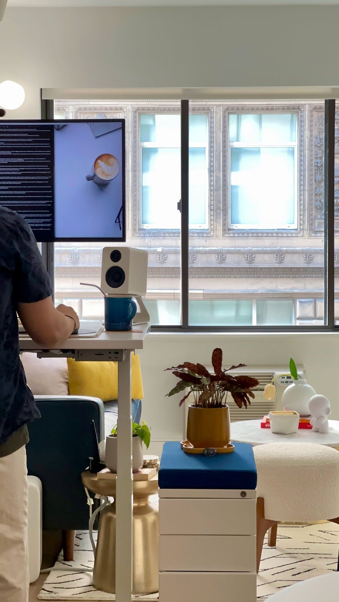 A person working from their standing desk setup