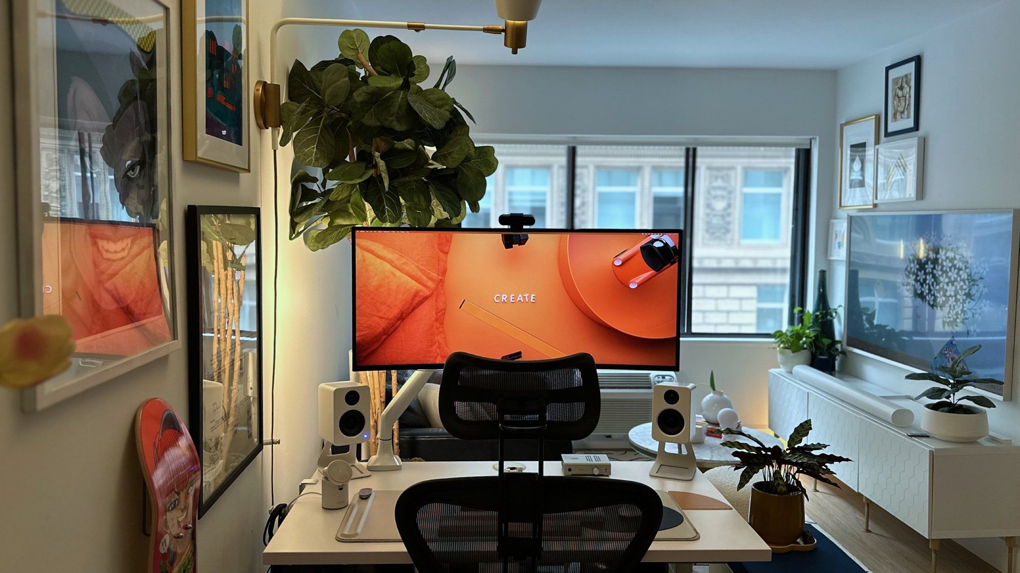 A small desk setup with an ultrawide LG monitor