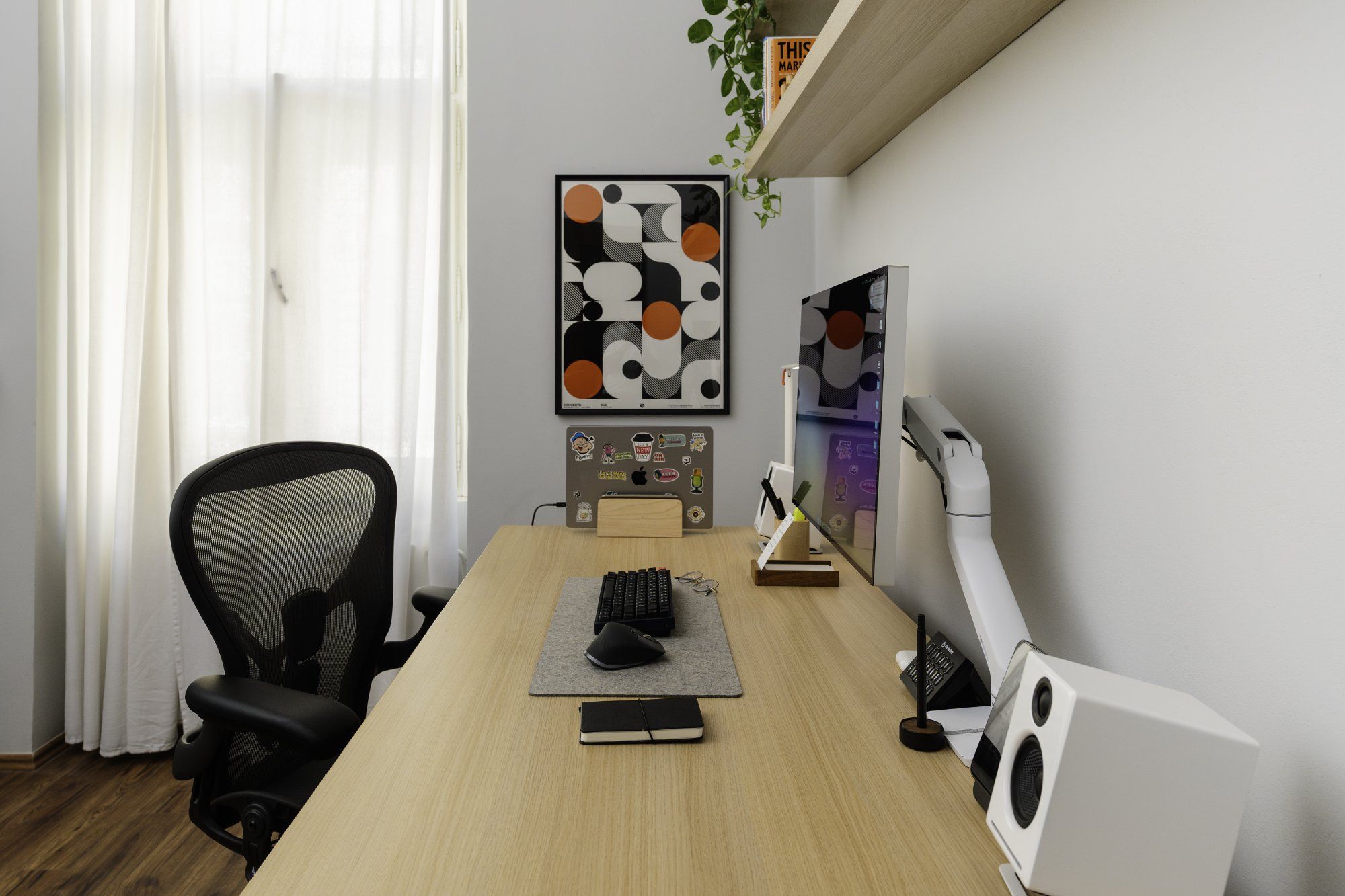 A side view of a well-organised, minimalist desk setup