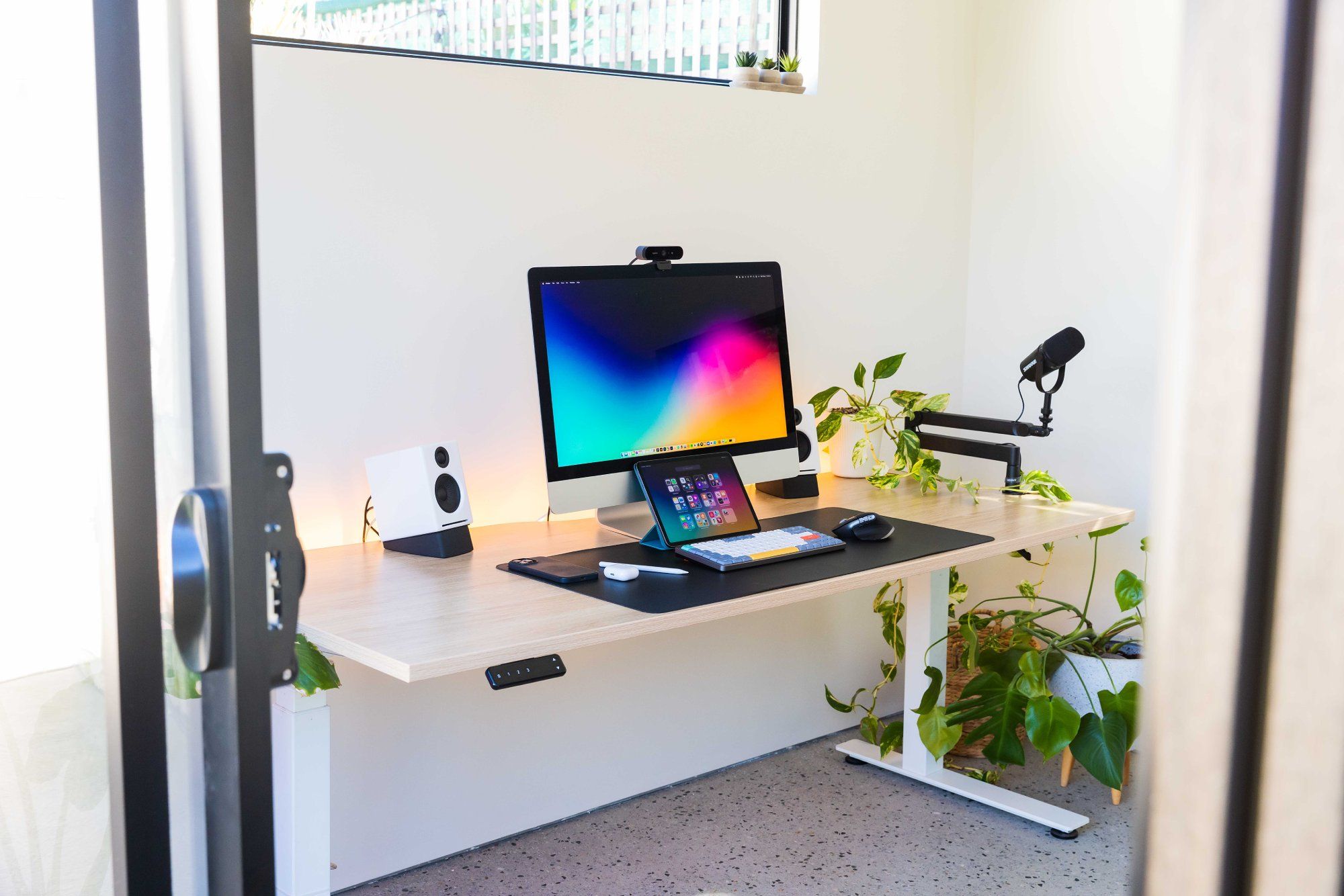 A small ergonomic desk setup in a garden shed