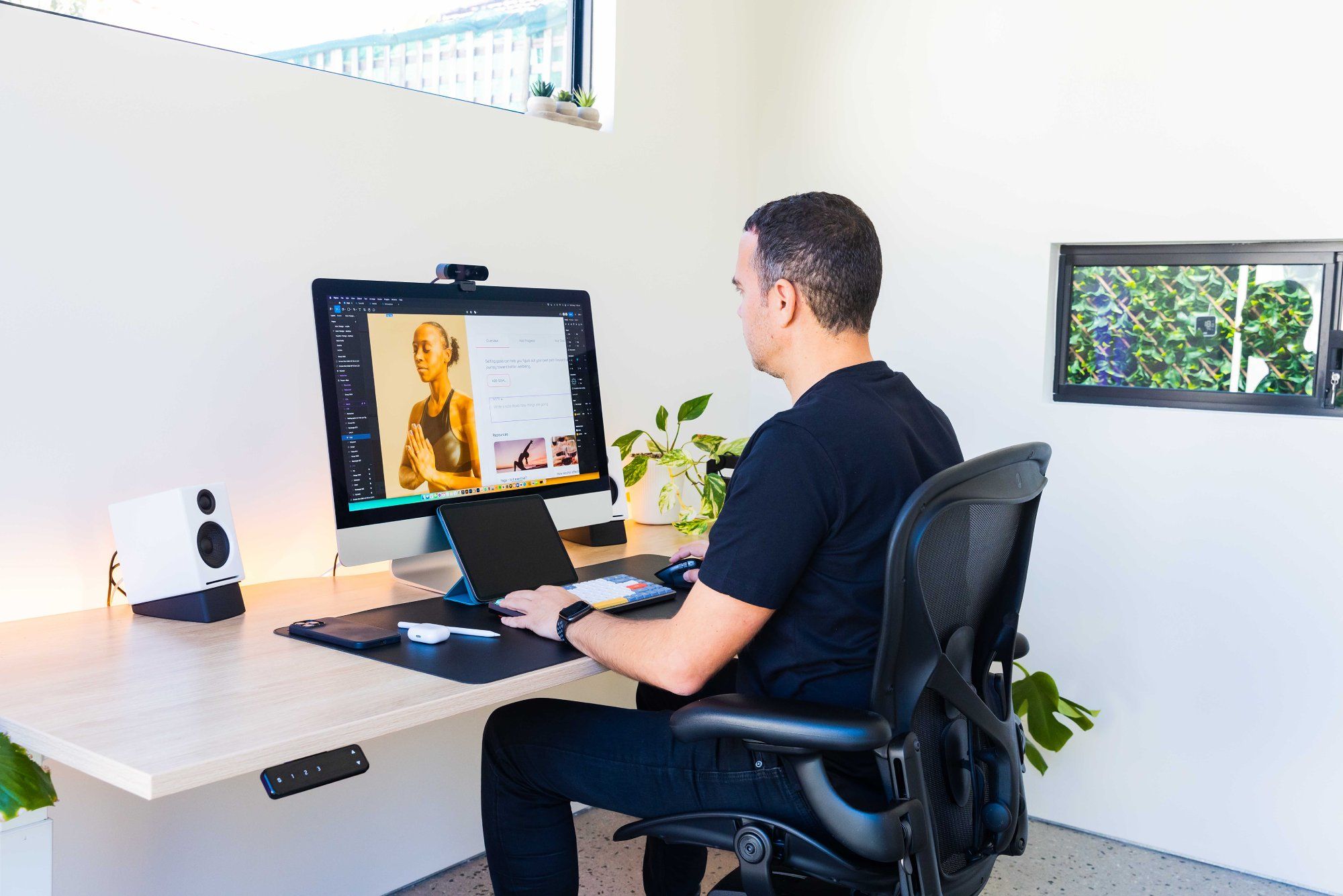 Petar Ceklic, a freelance UX/UI designer, in his garden home office in Australia