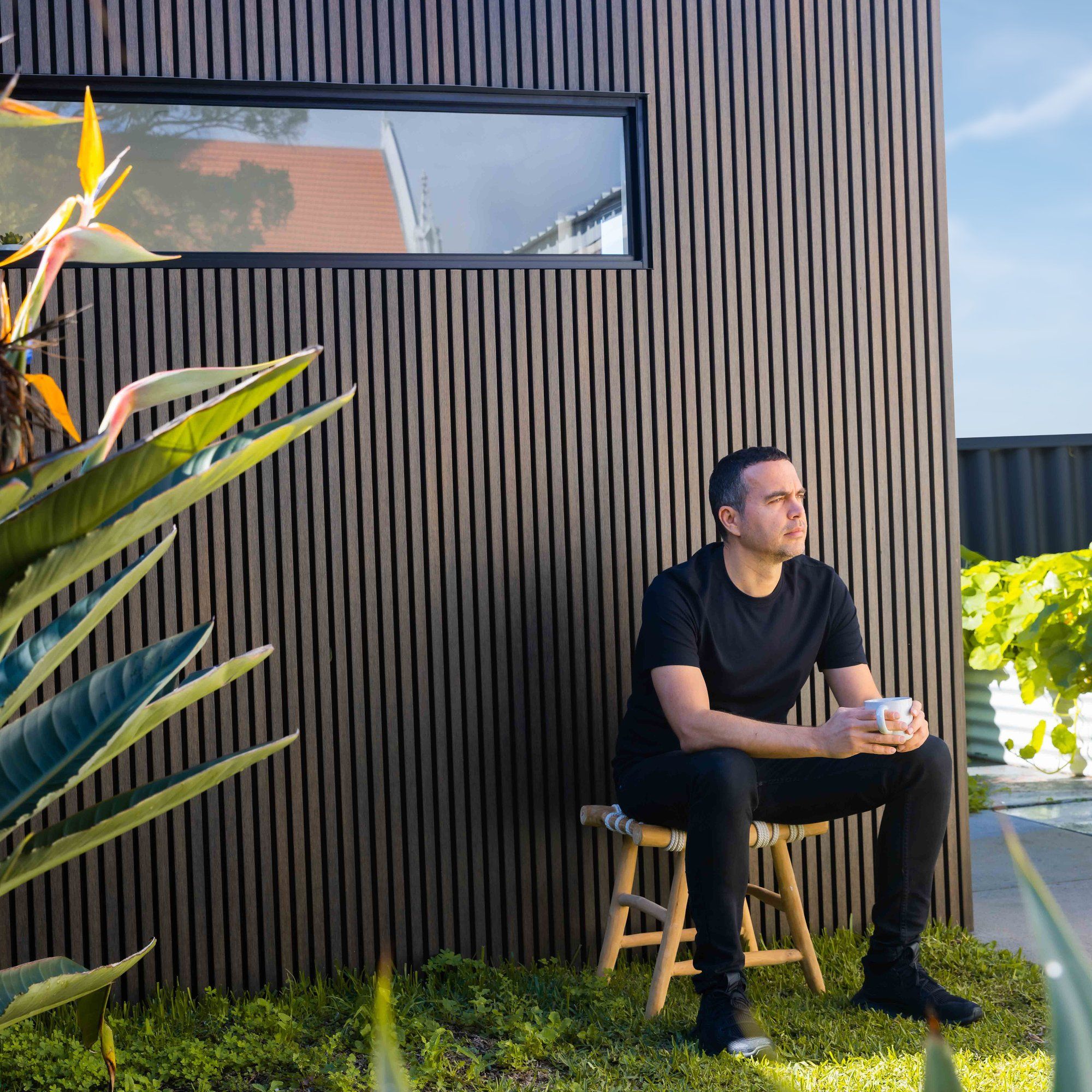 A WFH freelance designer taking a coffee break in the garden