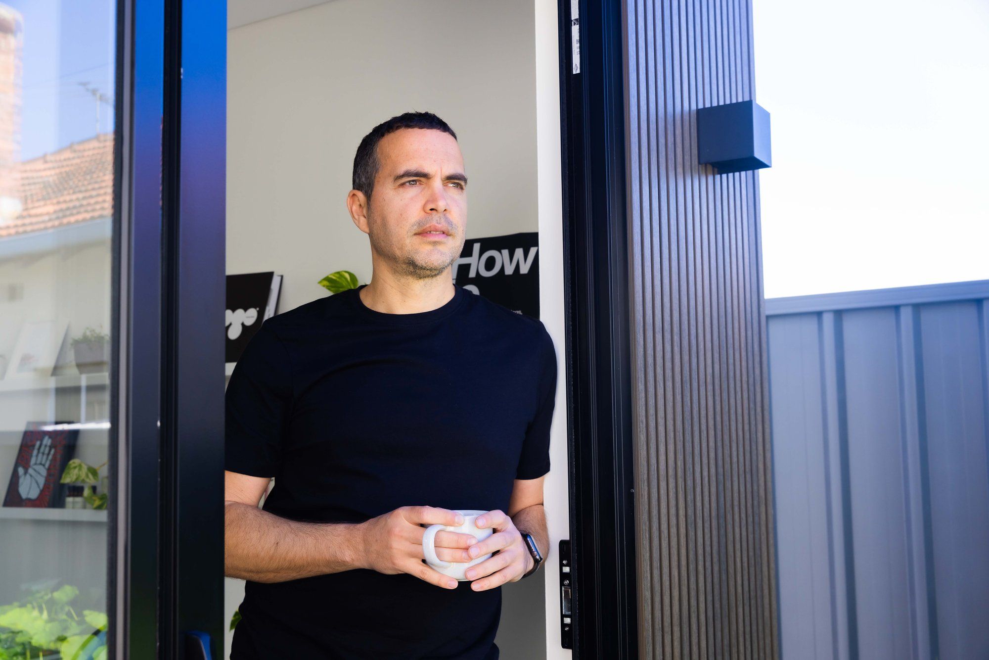 Petar Ceklic enjoying his morning coffee in his garden office pod