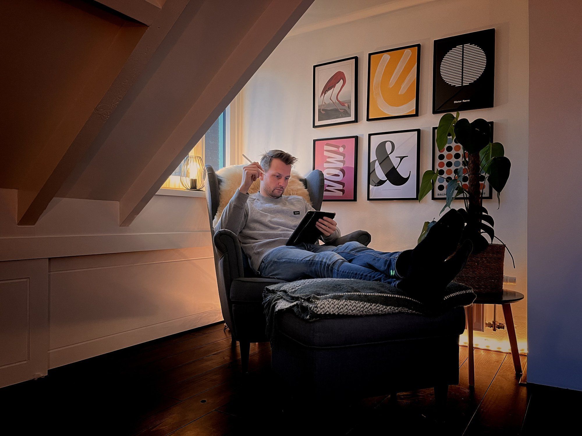 Wouter de Bres, a designer from the Netherlands, schedules his day as he sits on his IKEA STRANDMON armchair in his attic workspace
