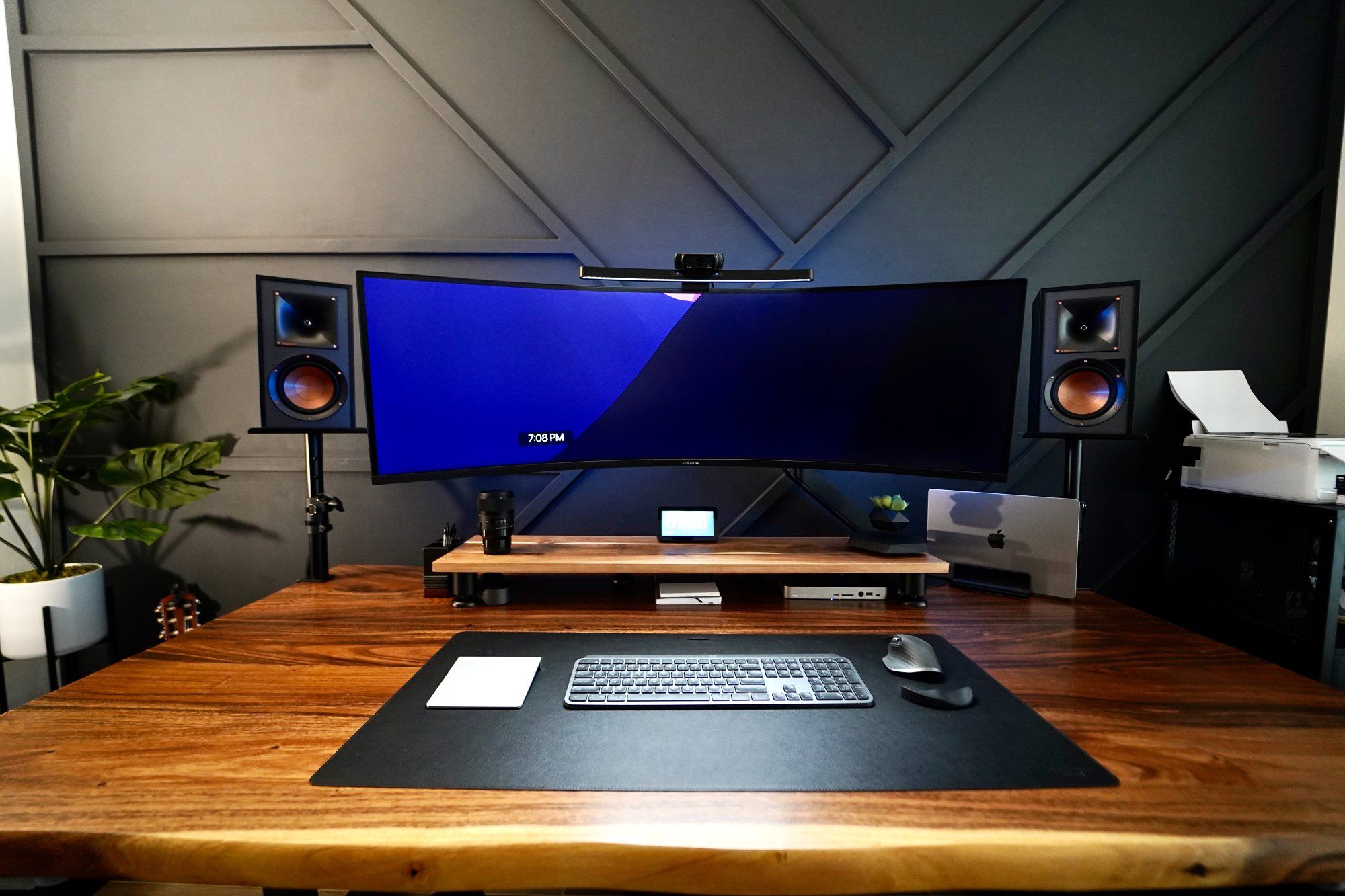 A moody home workstation with an ultrawide monitor