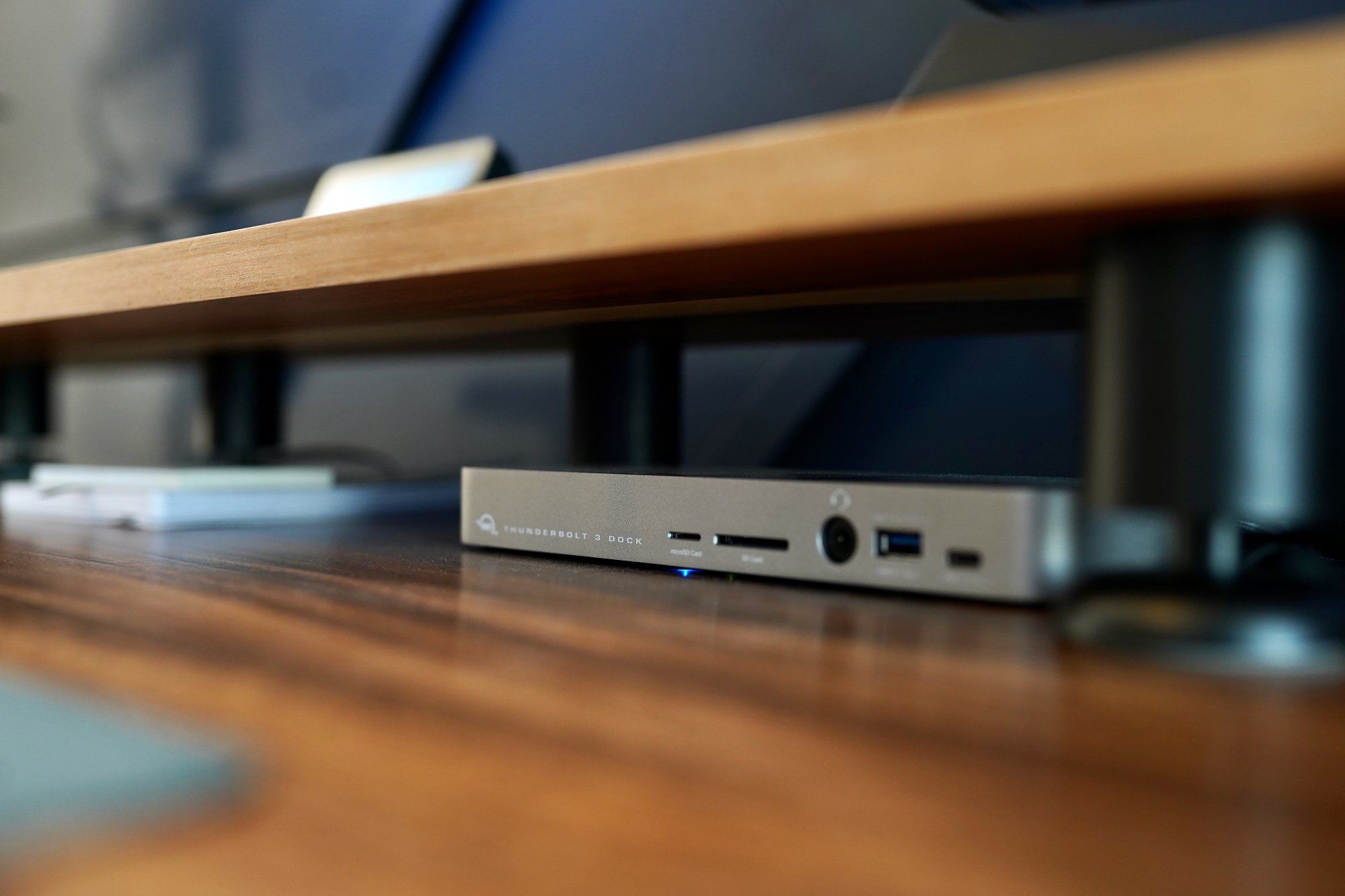 A Thunderbolt dock under the desk shelf