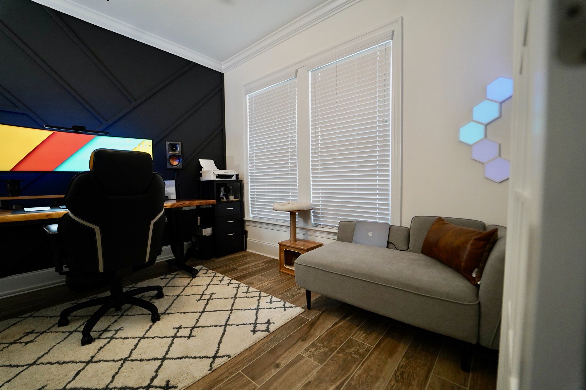 A home office setup and a small lounge sofa in a den