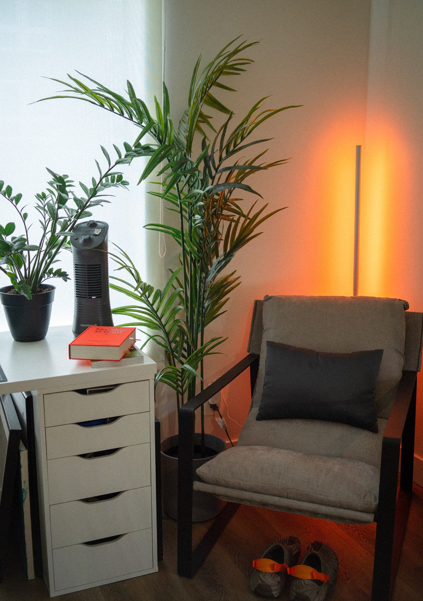 A corner of the home office with an armchair, an ALEX drawer, and two indoor plants