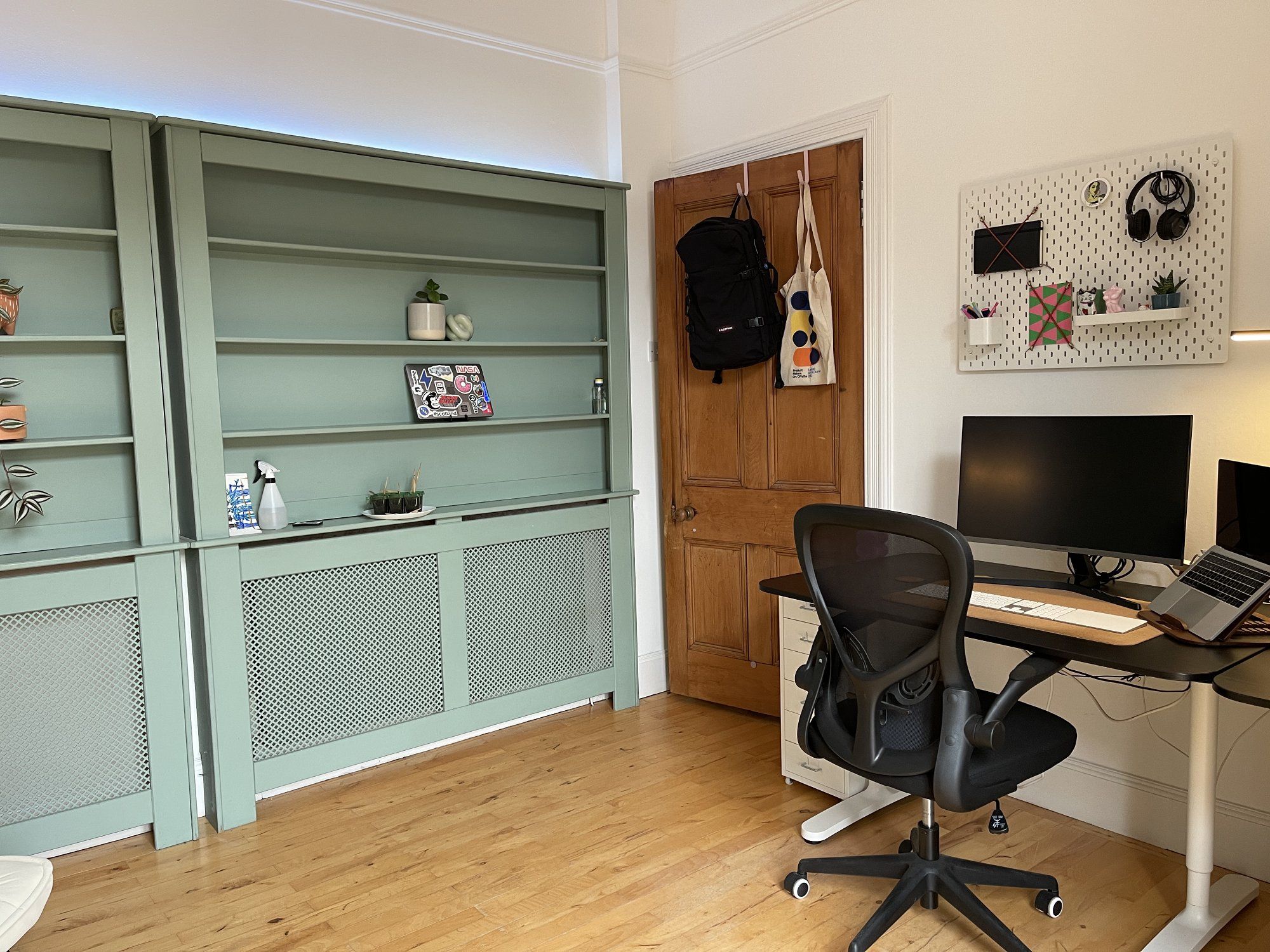 A home office with two olive radiator covers
