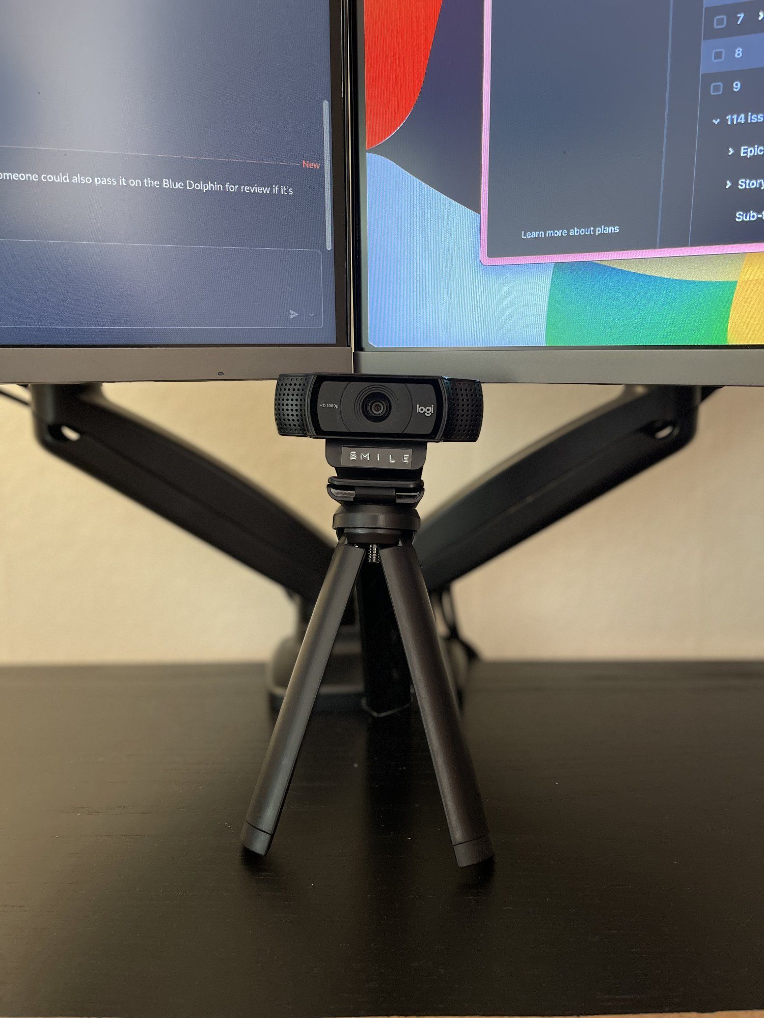 A Logitech webcam mounted on a tripod