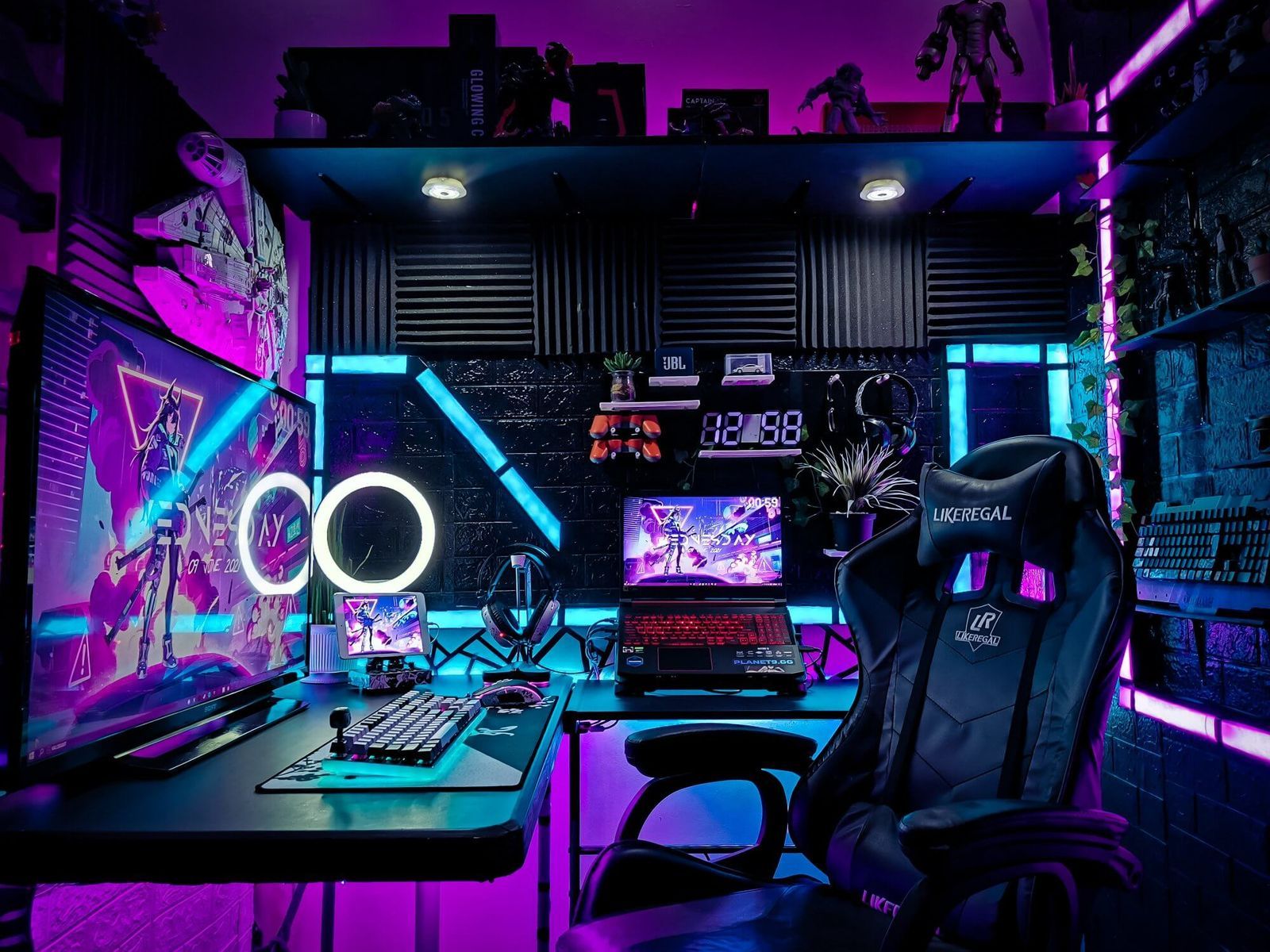 A vibrant gaming setup with neon lights, featuring multiple monitors, a gaming chair, and decorative figures. The room is bathed in purple and blue light, creating a dynamic atmosphere