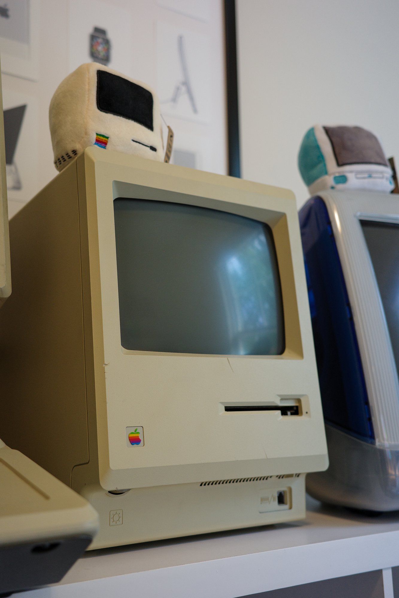 The Macintosh 512K and a couple of small plush toys shaped like classic Macintosh computers