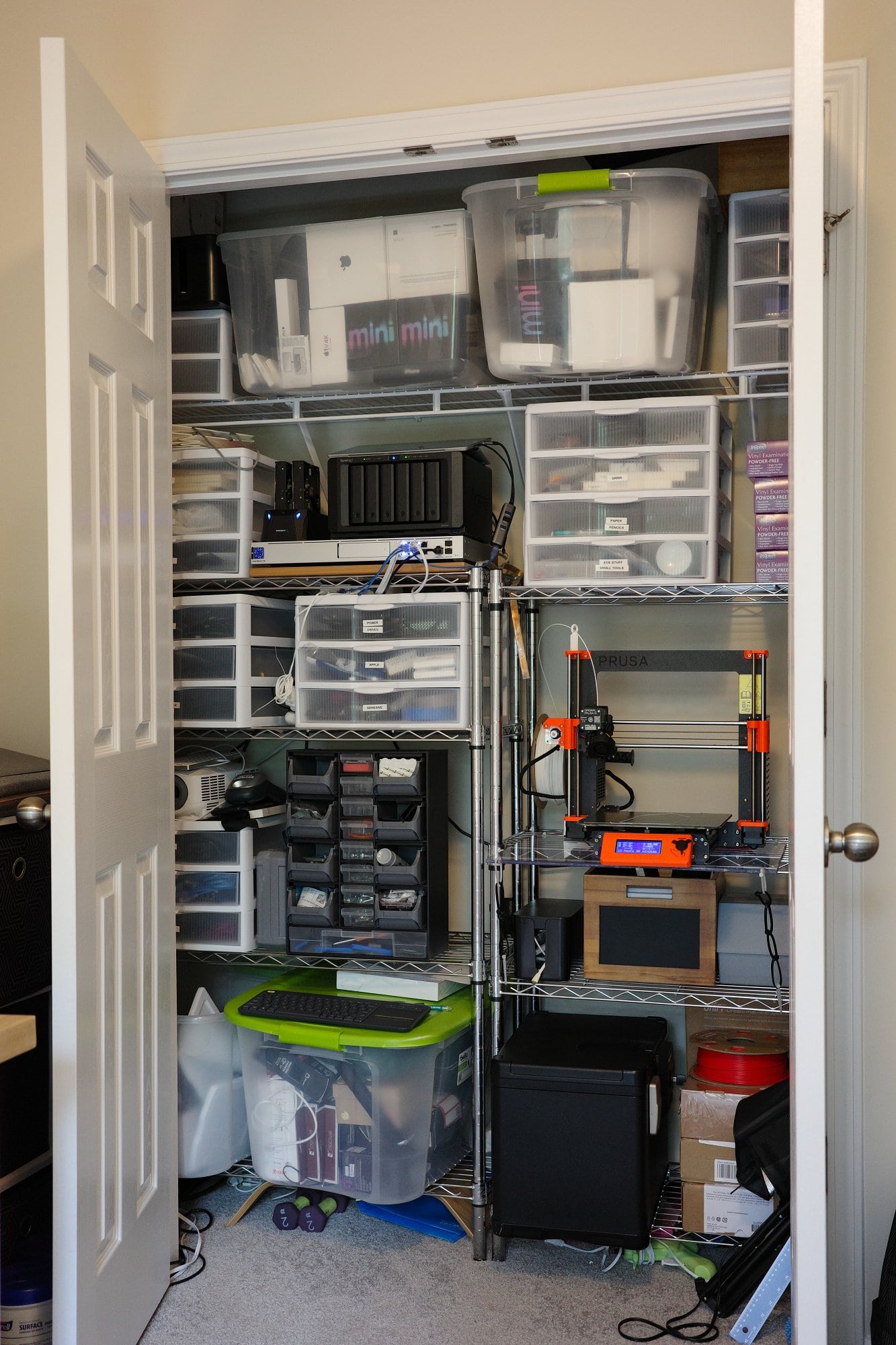 A well-organised storage closet, primarily containing technological equipment and accessories