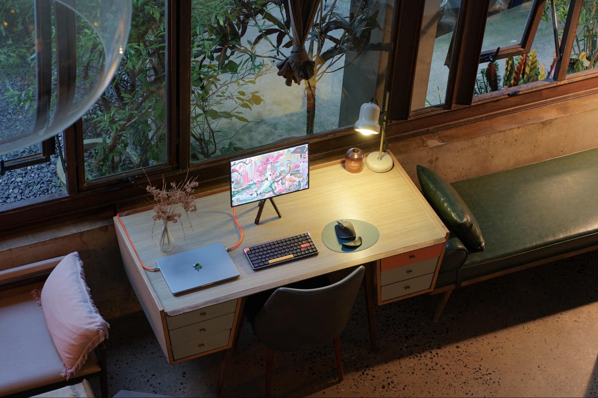 A view from above of an unusual portable desk setup with orange cables