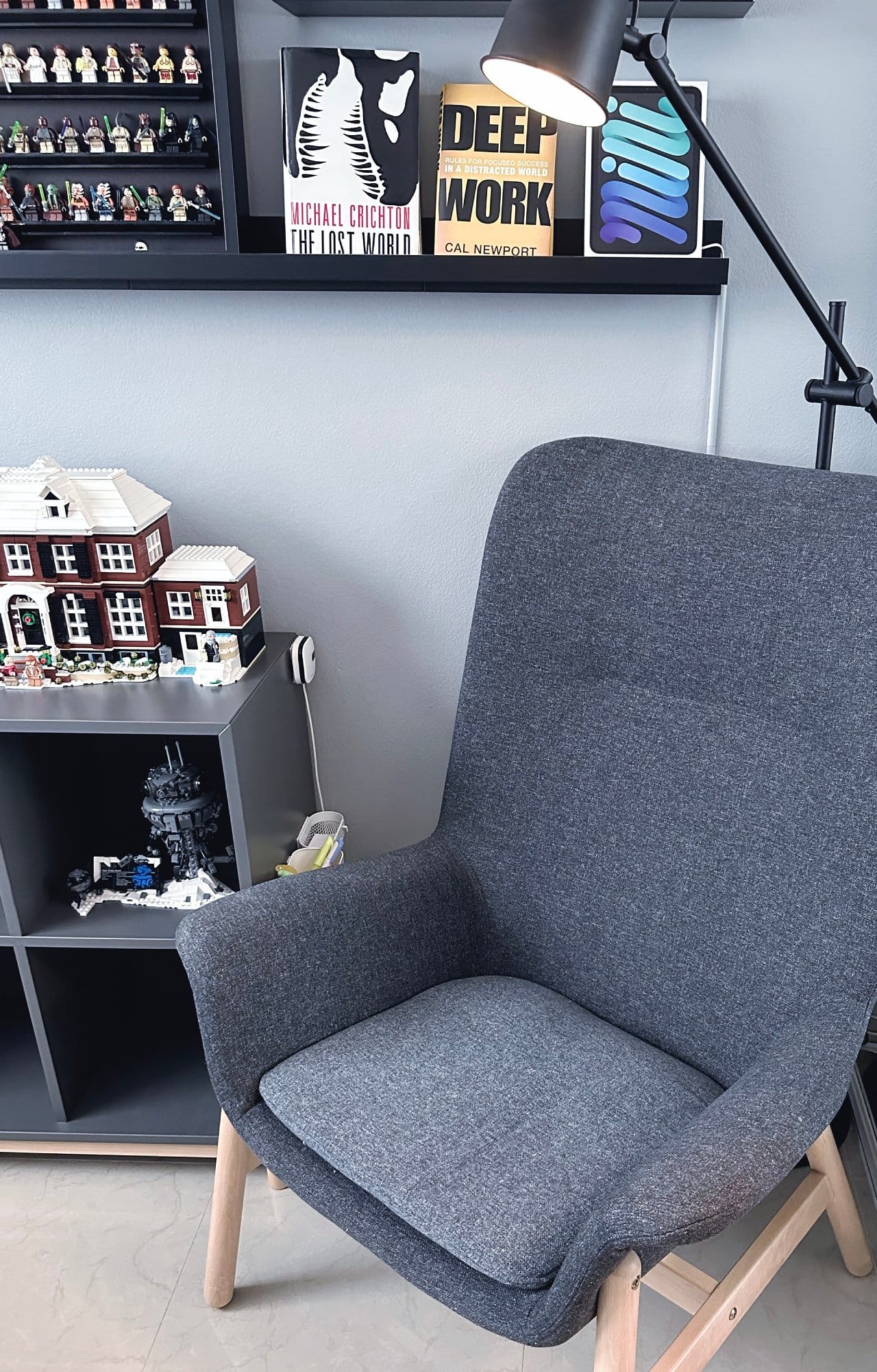 An IKEA VEDBO high-back armchair and some LEGO scenes in the background