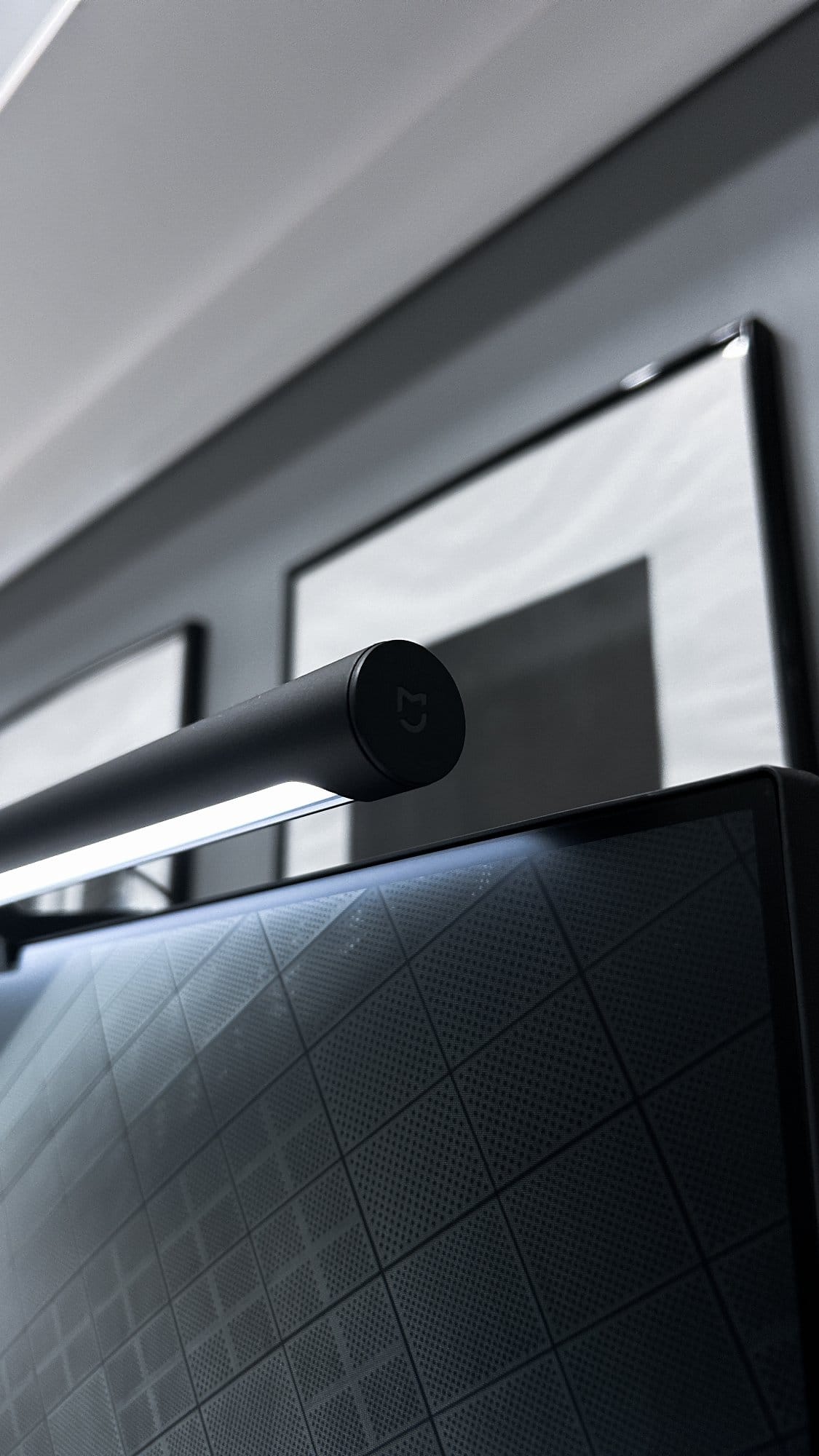 A close-up of a sleek, modern Xiaomi monitor light bar on top of a computer screen