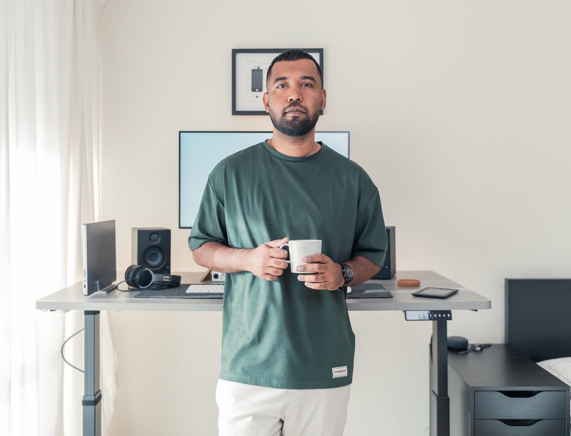 A portrait of Tony Sam Noel, a multimedia designer from Dubai, in his home office