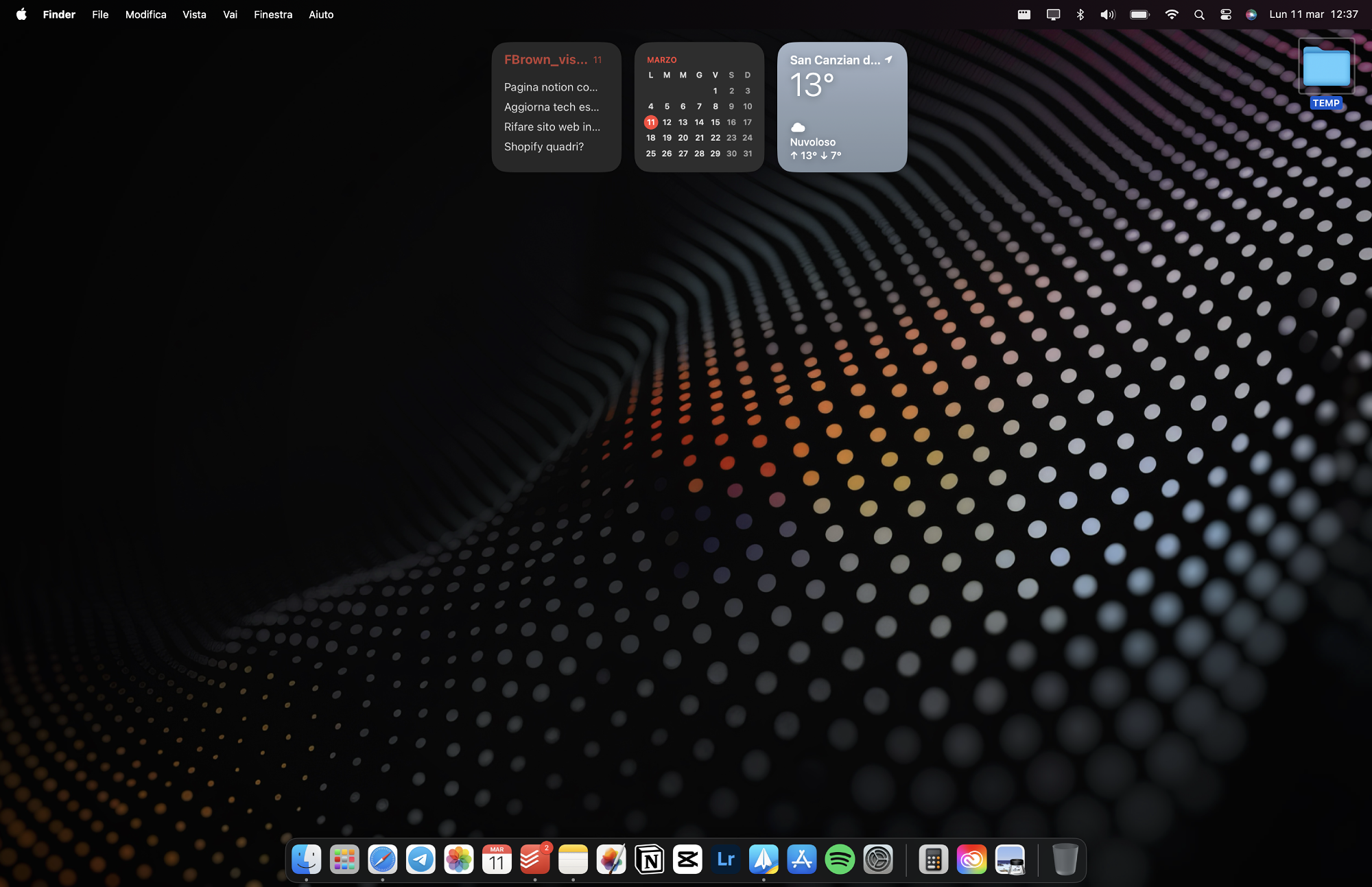 A MacBook screen displaying a desktop wallpaper with a dot matrix design, overlaid by various application icons and a weather widget