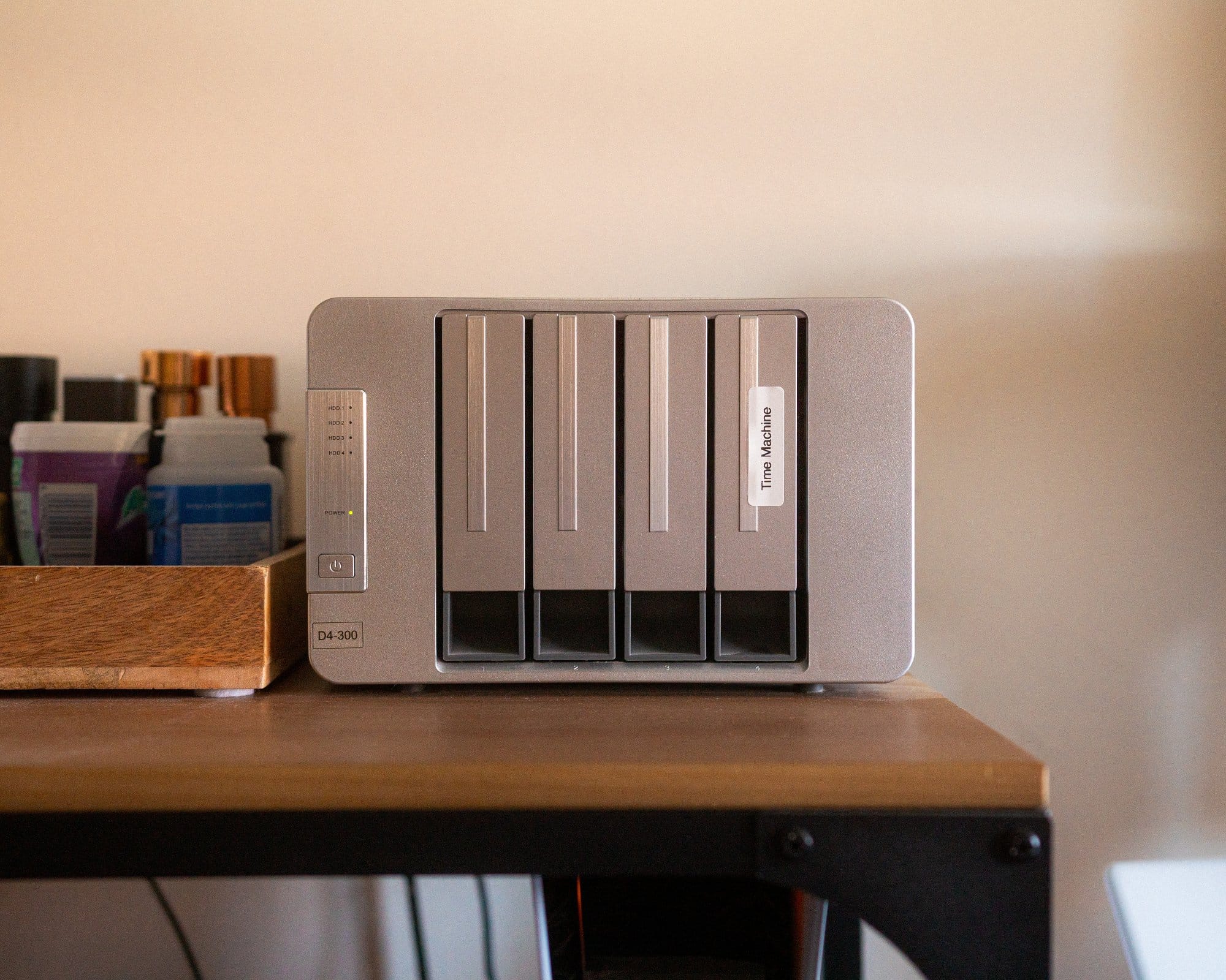 A TerraMaster D4-300 USB3.1 hard drive/SSD enclosure on a desk, with the brand label visible, providing a sleek storage solution