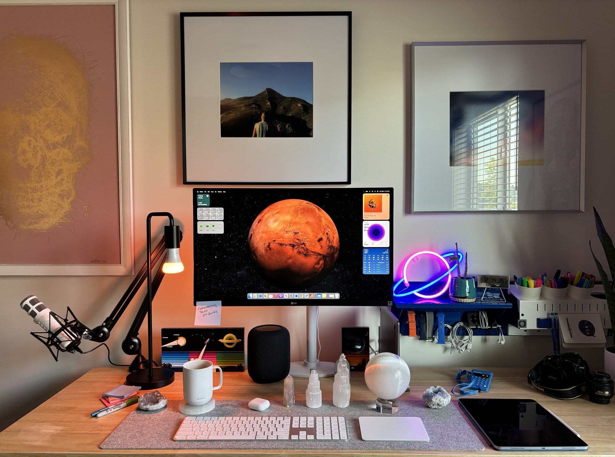 A desk setup with an LG 27″ IPS 4K UHD monitor, a RØDE Podcaster microphone on a RØDE PSA1 boom arm, an Apple Magic Keyboard with Touch ID, an Apple Magic Trackpad, and a BeaverPeak Felt Desk Pad on a Husky workbench