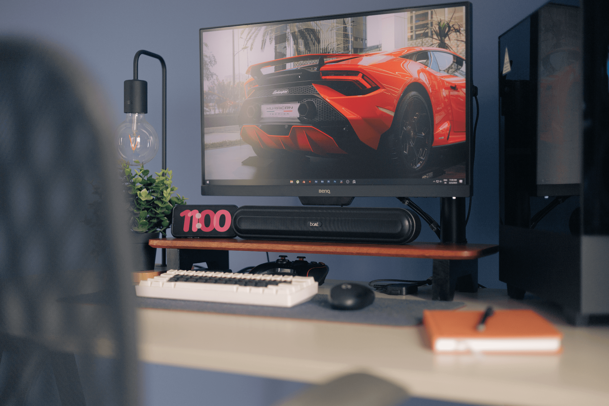 A desk setup with a BenQ PD2500Q monitor, a boAt Aavante Bar 490 speaker, and an EPOMAKER Skyloong SK61 keyboard on a Carpentray wooden shelf