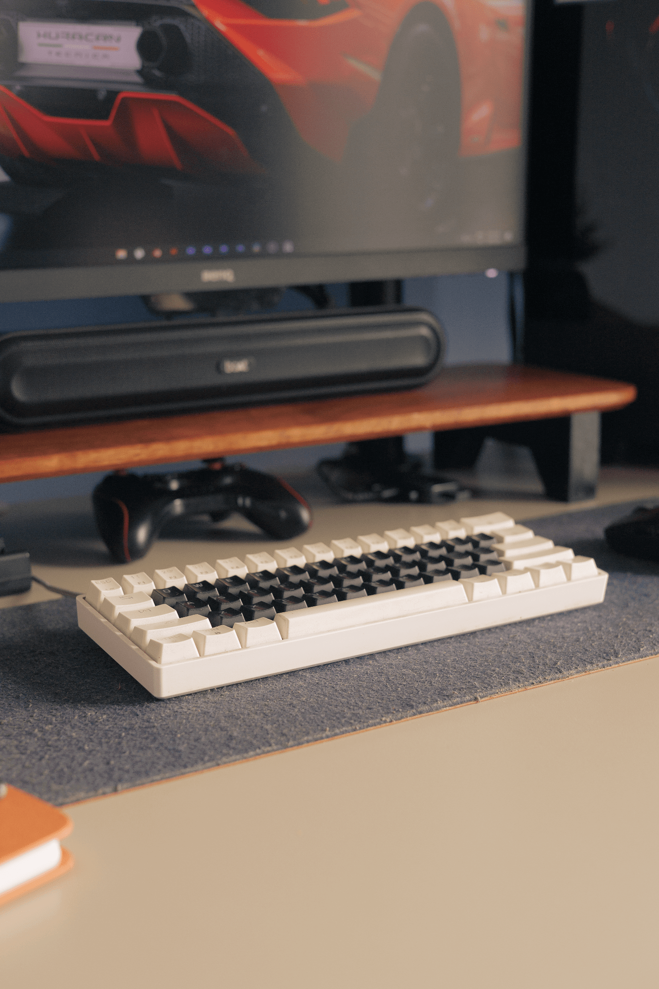 A desk setup with an EPOMAKER Skyloong SK61 keyboard, a boAt Aavante Bar 490 speaker, and a BenQ PD2500Q monitor