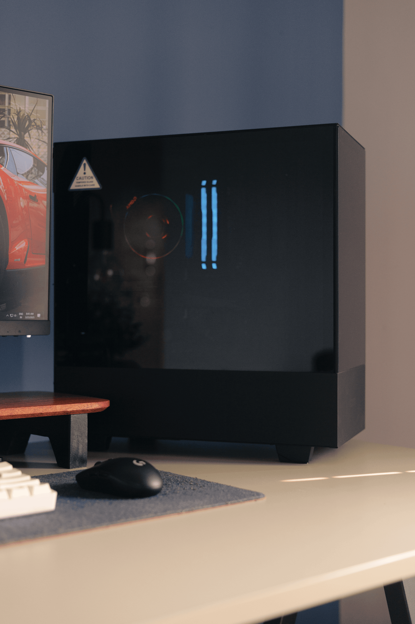 A desk setup with a Logitech G305 mouse, an EPOMAKER Skyloong SK61 keyboard, and a custom-built PC next to a BenQ PD2500Q monitor