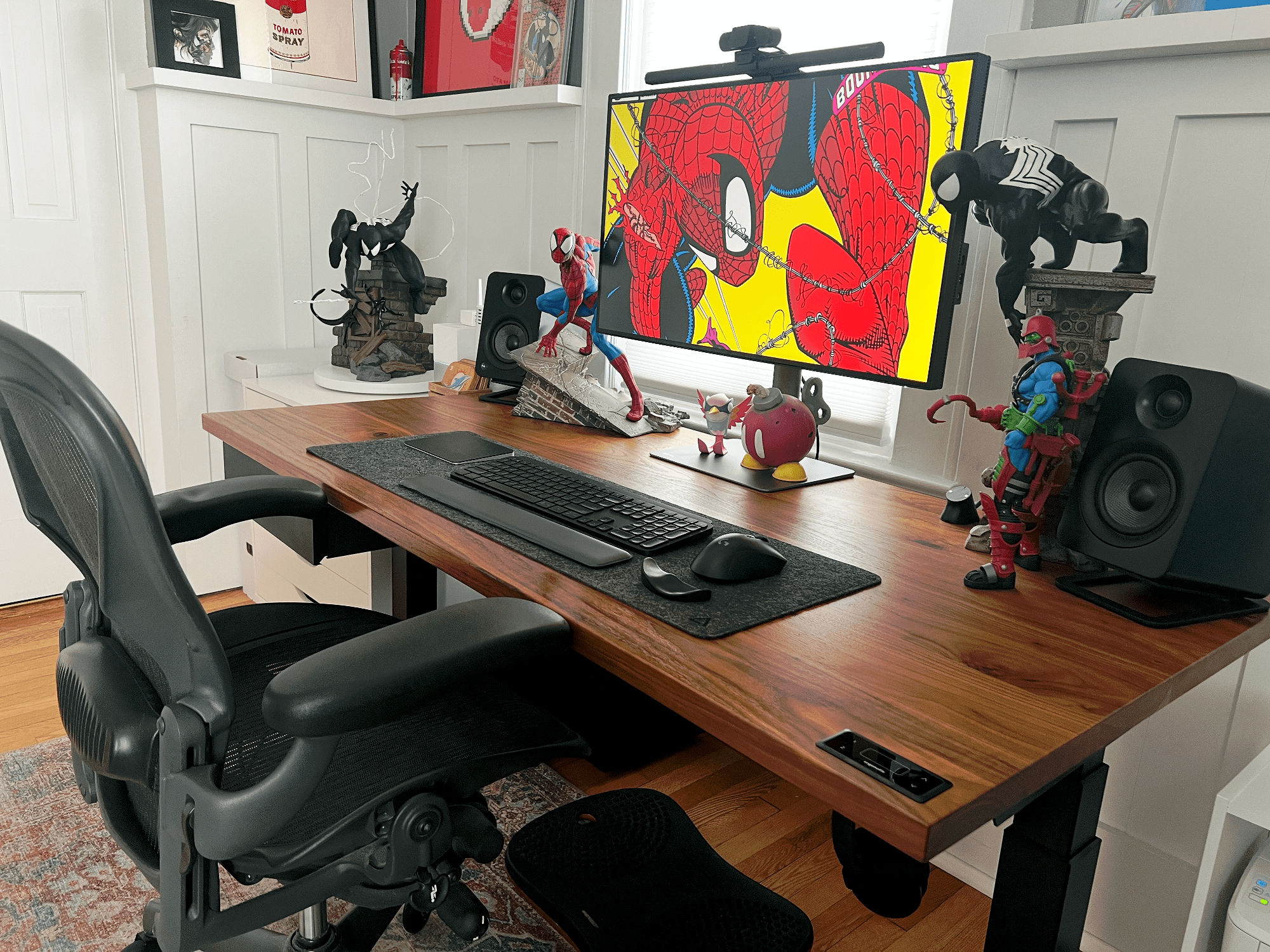 A desk setup with Spider-Man art, BenQ monitor and Herman Miller Aeron chair