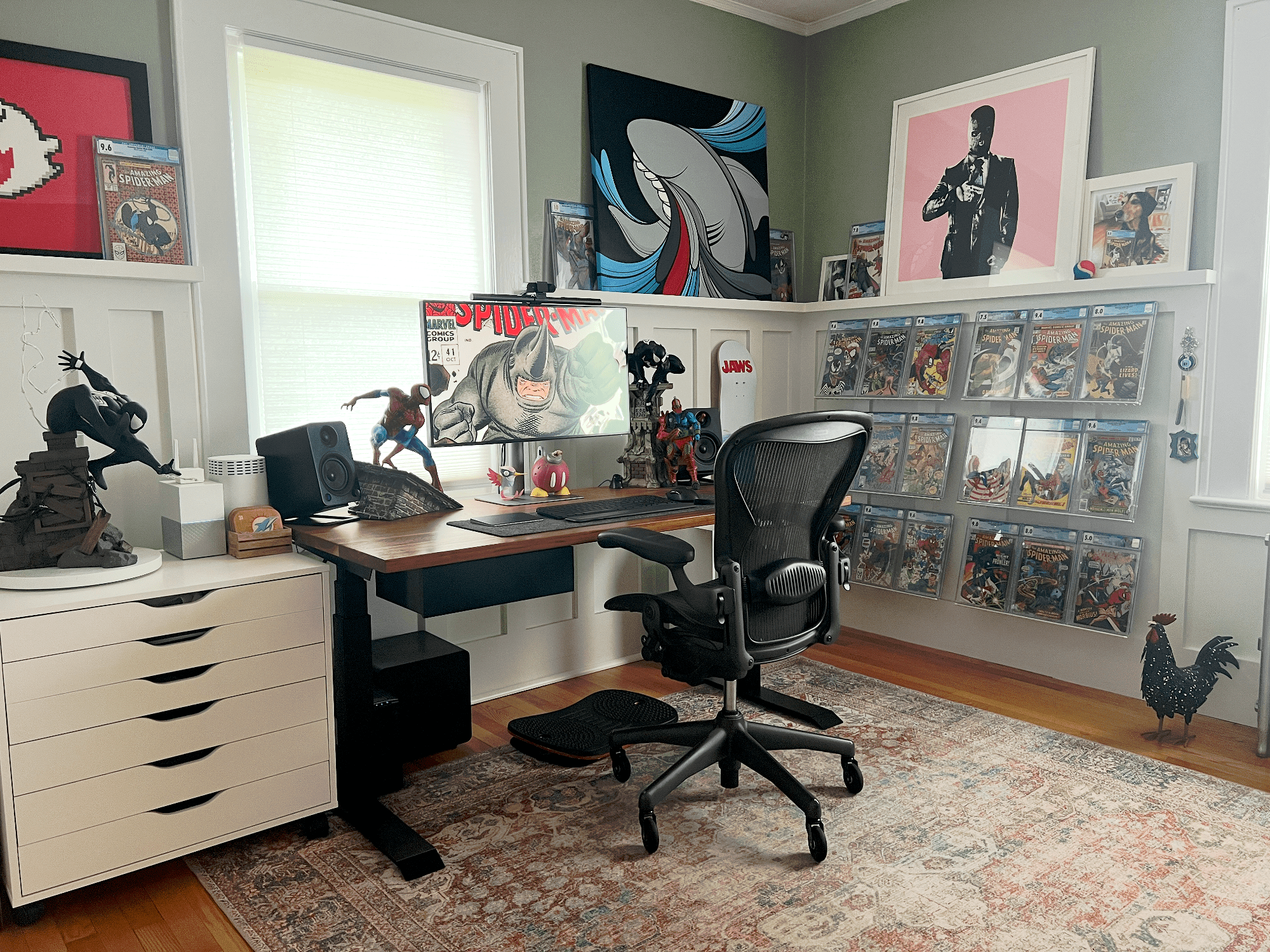 A home office with comic book art, BenQ monitor and Herman Miller Aeron chair
