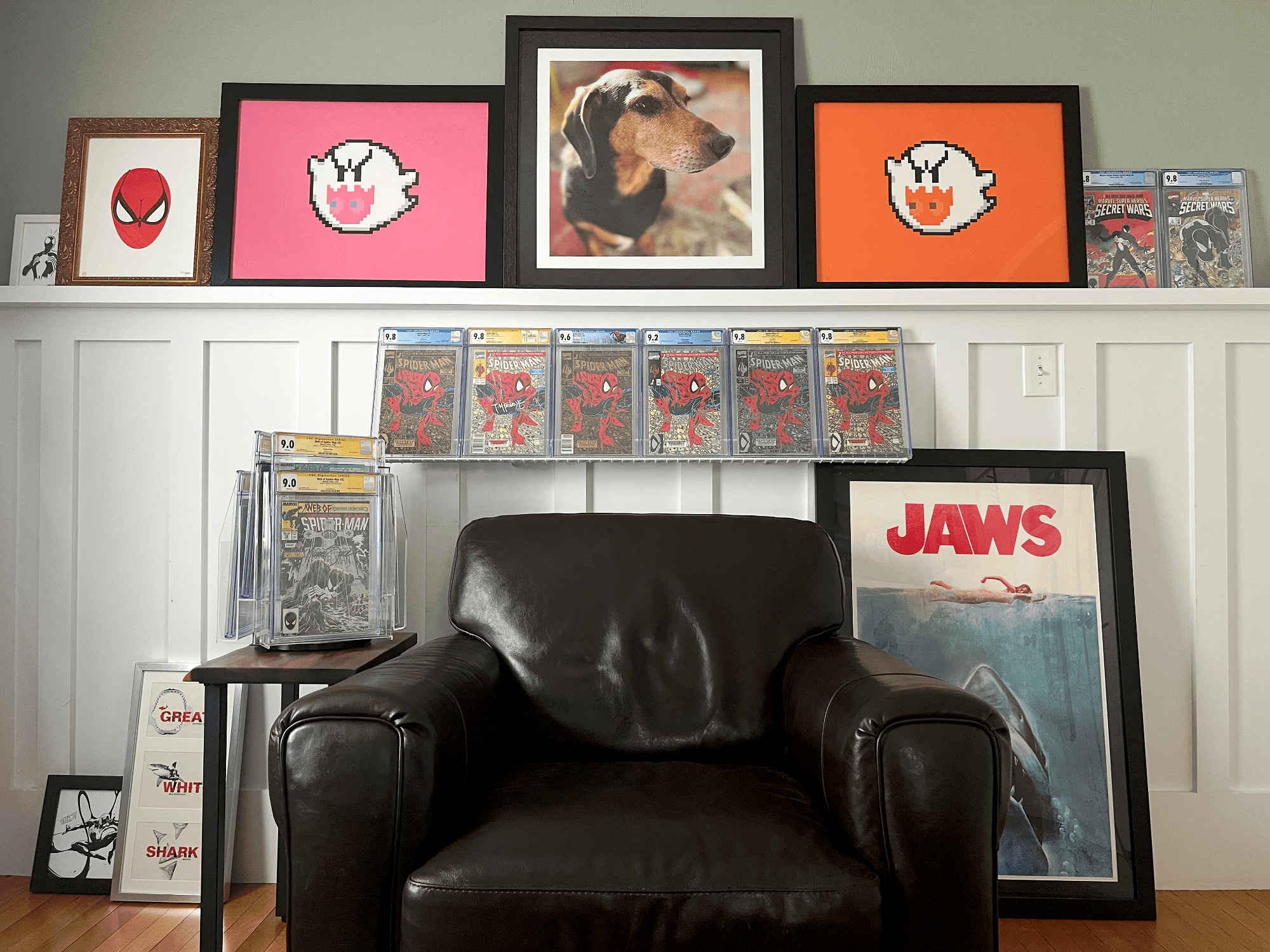 A reading corner with Spider-Man comics, Jaws poster and a leather armchair