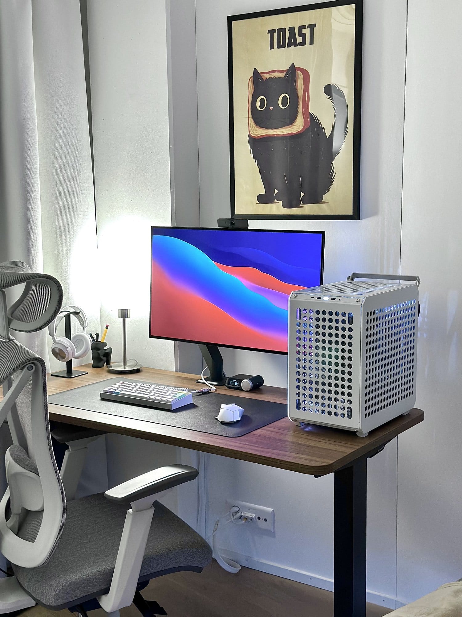 A desk setup with a Cooler Master QUBE 500 Flatpack PC case, LG UltraGear 32GS95UE-B monitor and Desktronic SitPro chair indoors