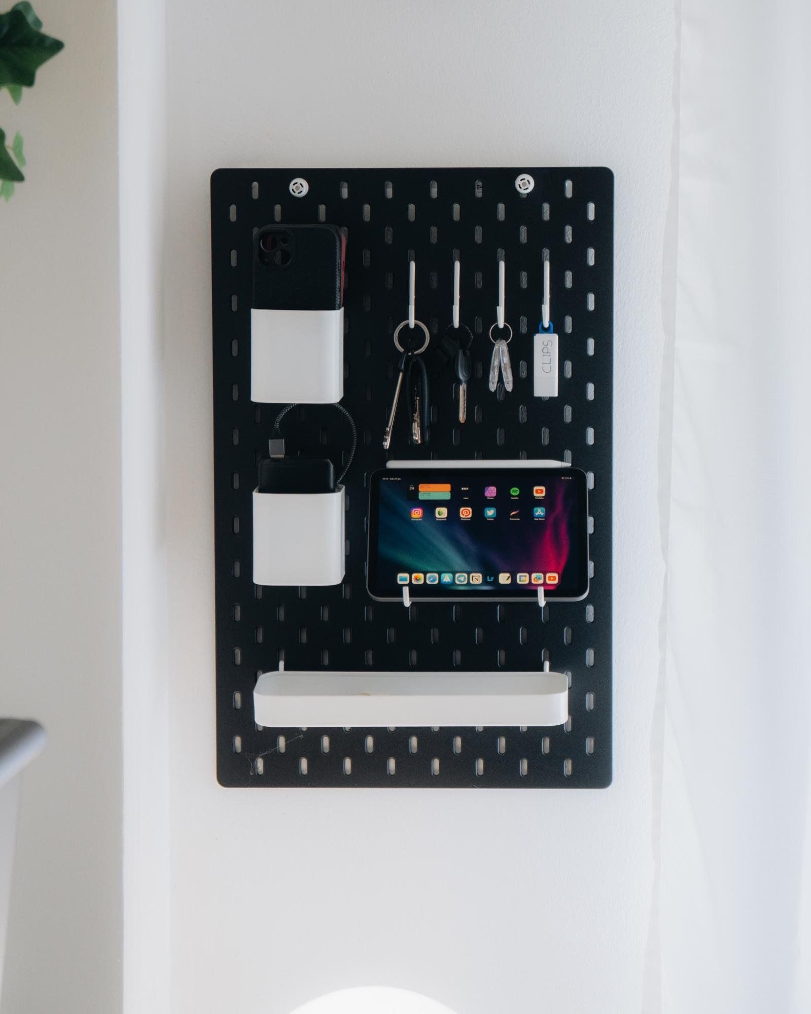 A black IKEA SKÅDIS pegboard